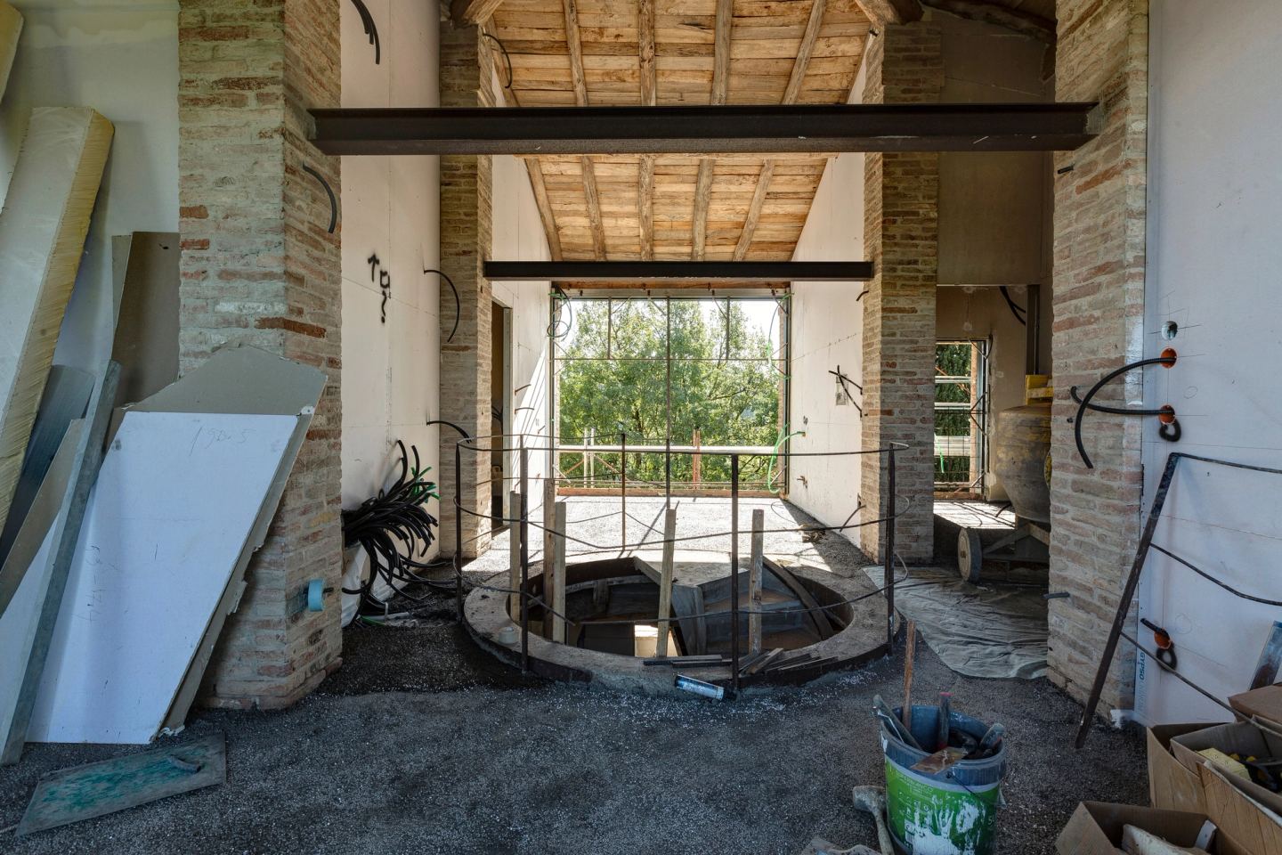 The upper floor under the timber roof, the stairwell in the middle