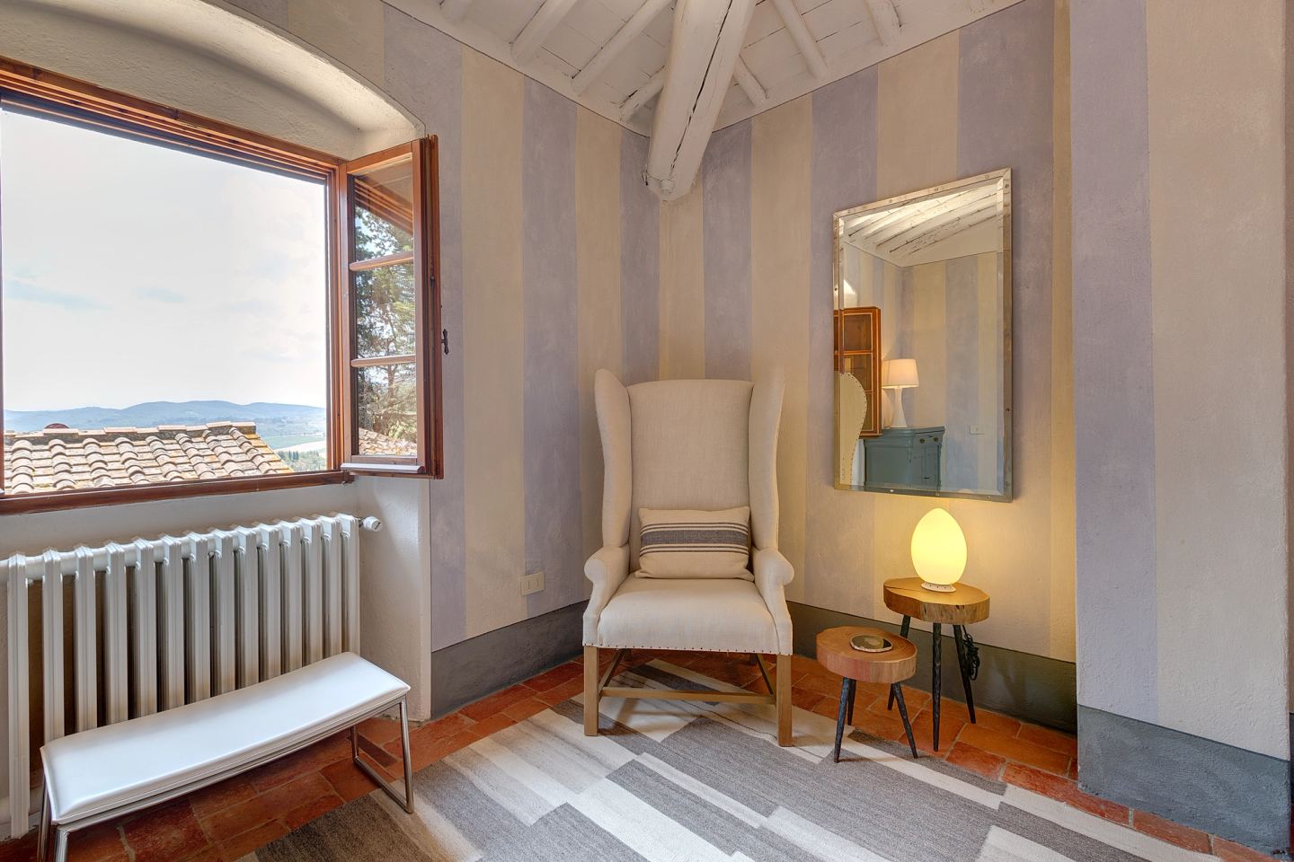 Chairs by the window, the lamp lit