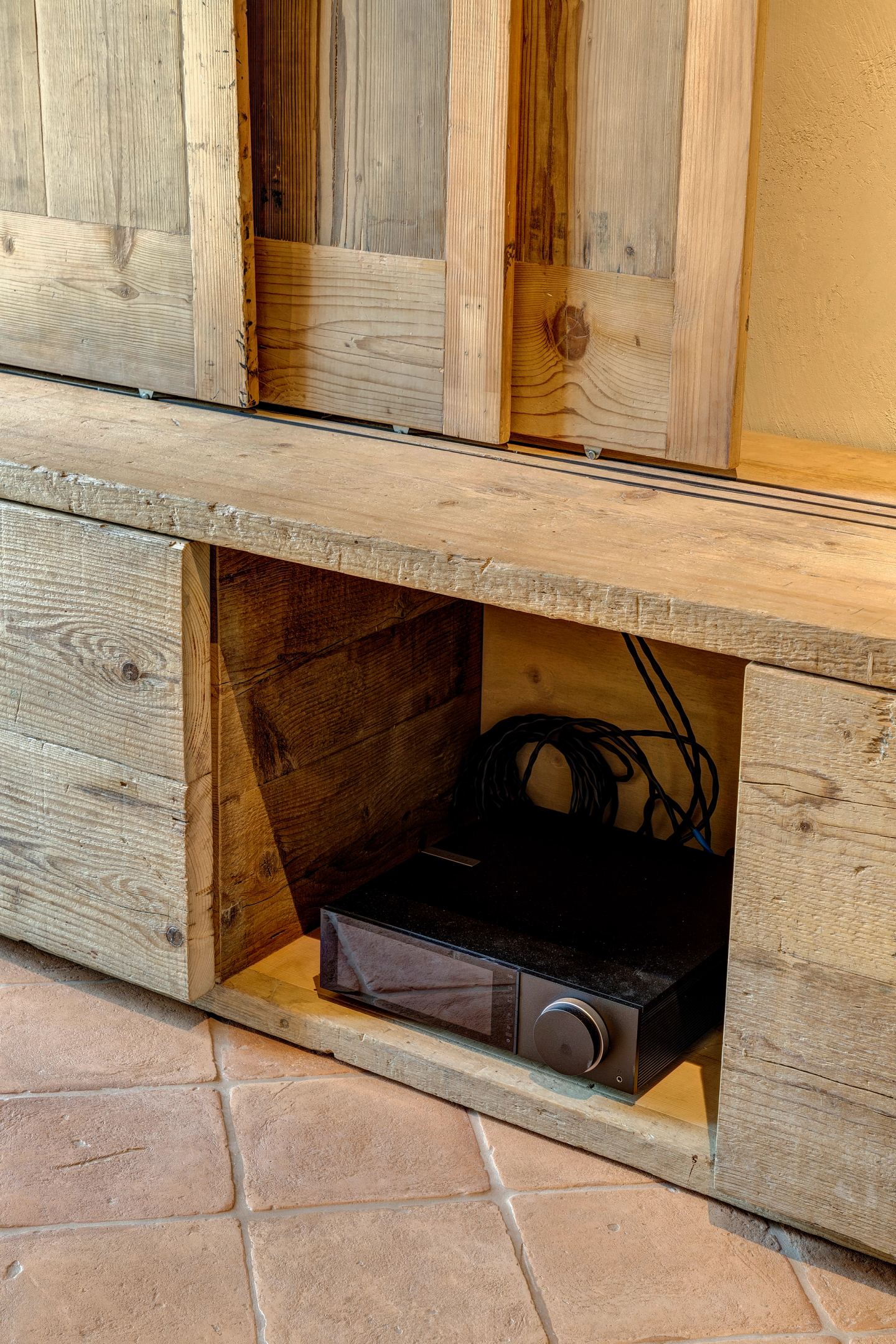 A timber panel open on the media niche
