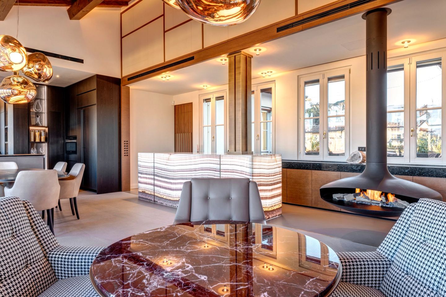 The seating group with the fire lit and the dining table beyond