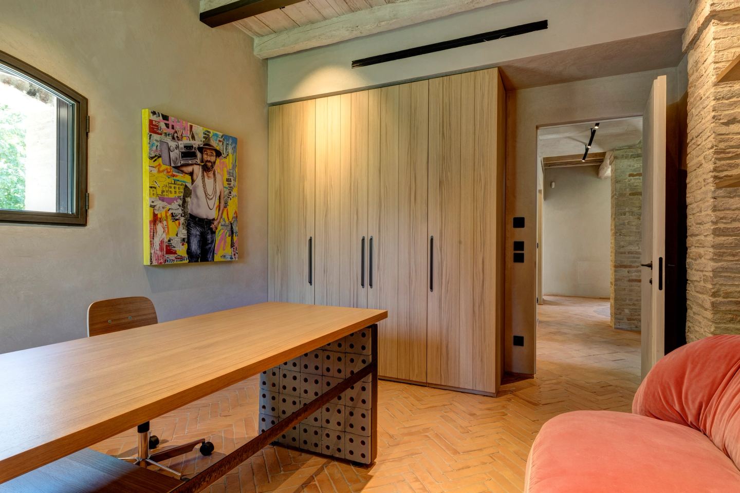 The long desk, the closet wall, the painting above