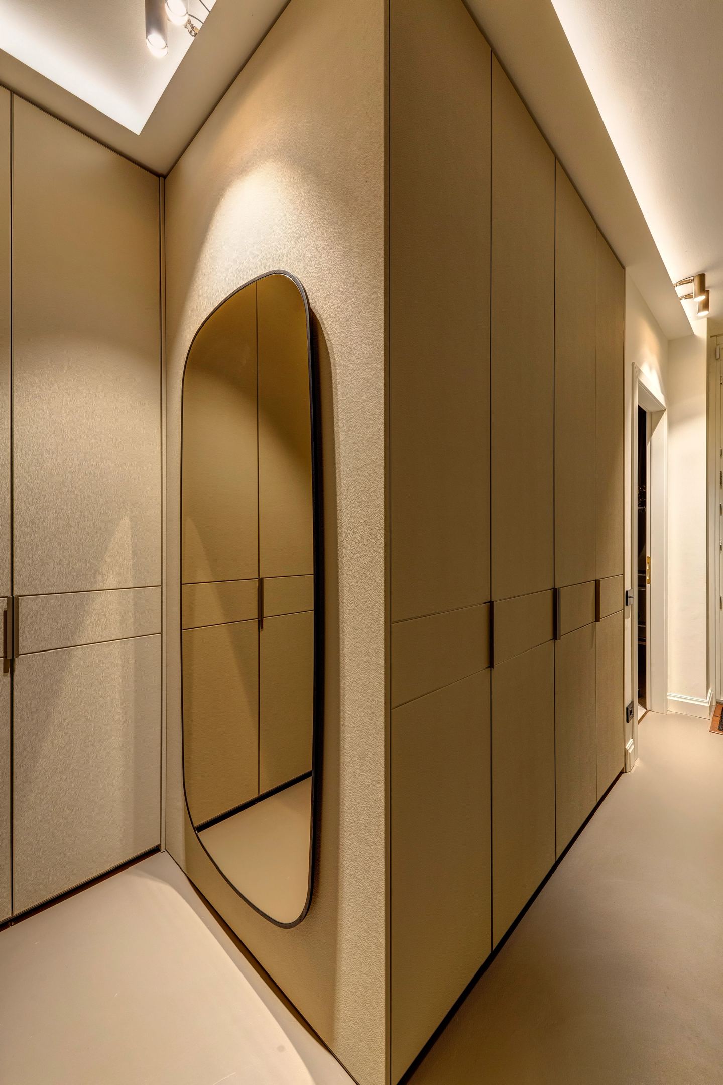 The dressing corridor at night, the oval mirror catching the light