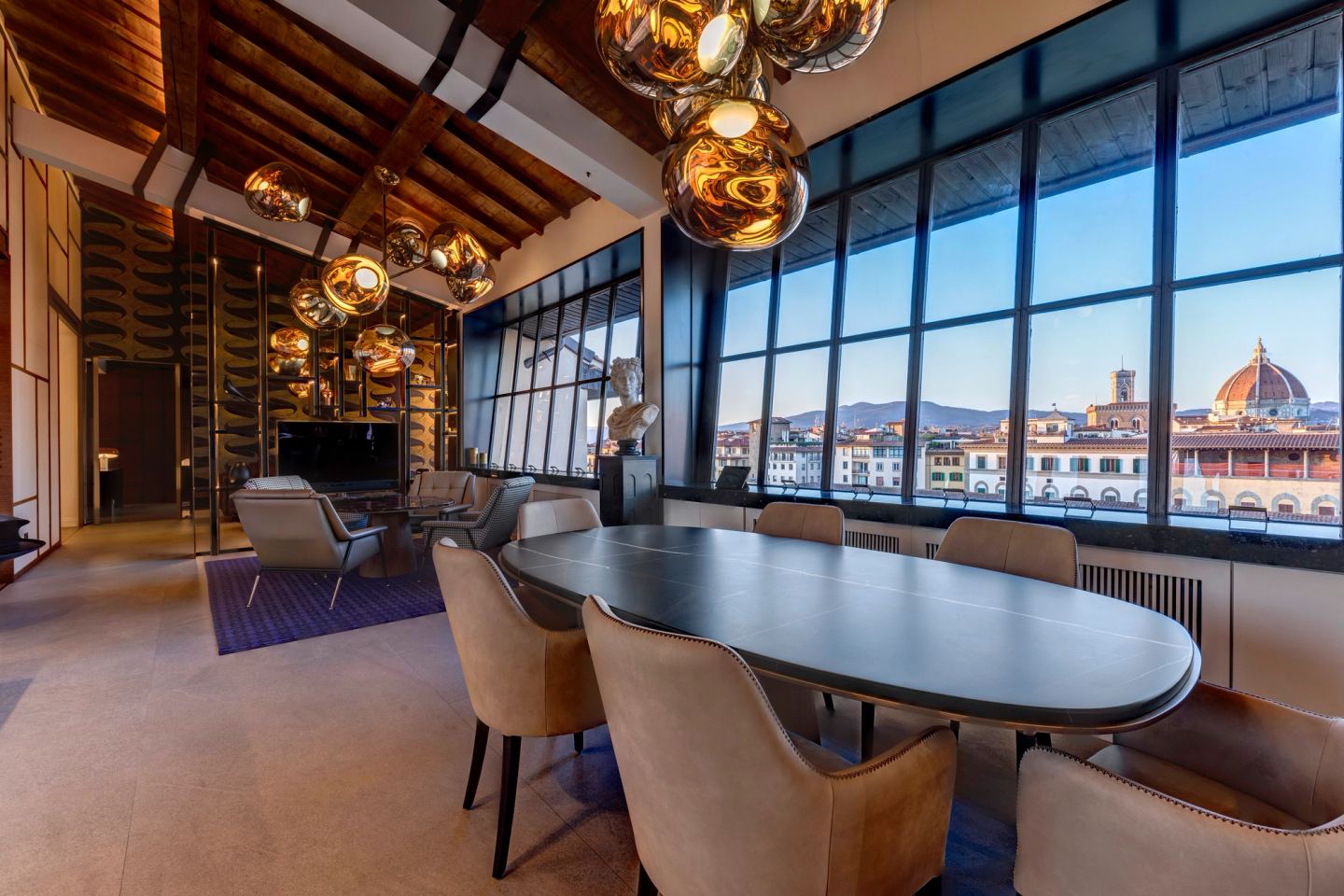 The long table under the globes, the city filling the glass