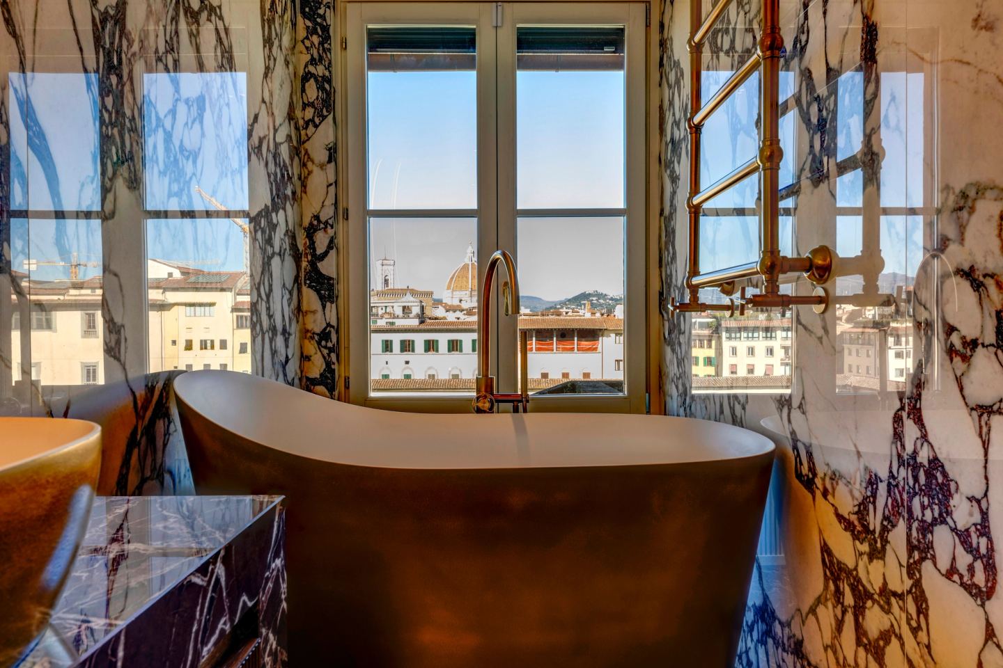The bath with the rooftops and the campanile beyond