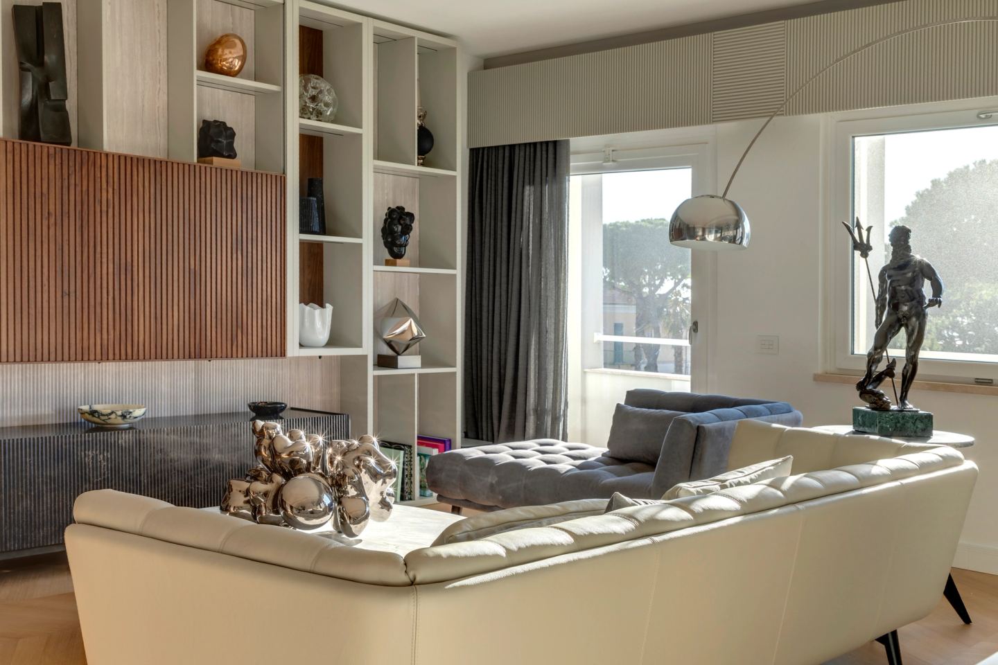 The room from the shelving wall, sofa and sculpture in the light