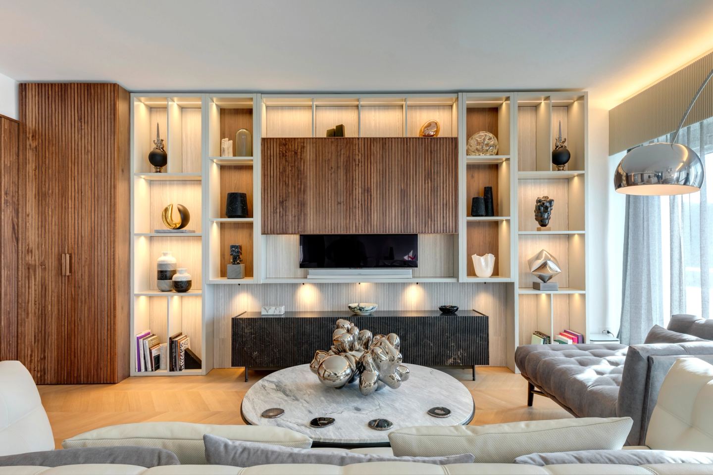 Walnut and lacquer shelving with concealed lighting, television open