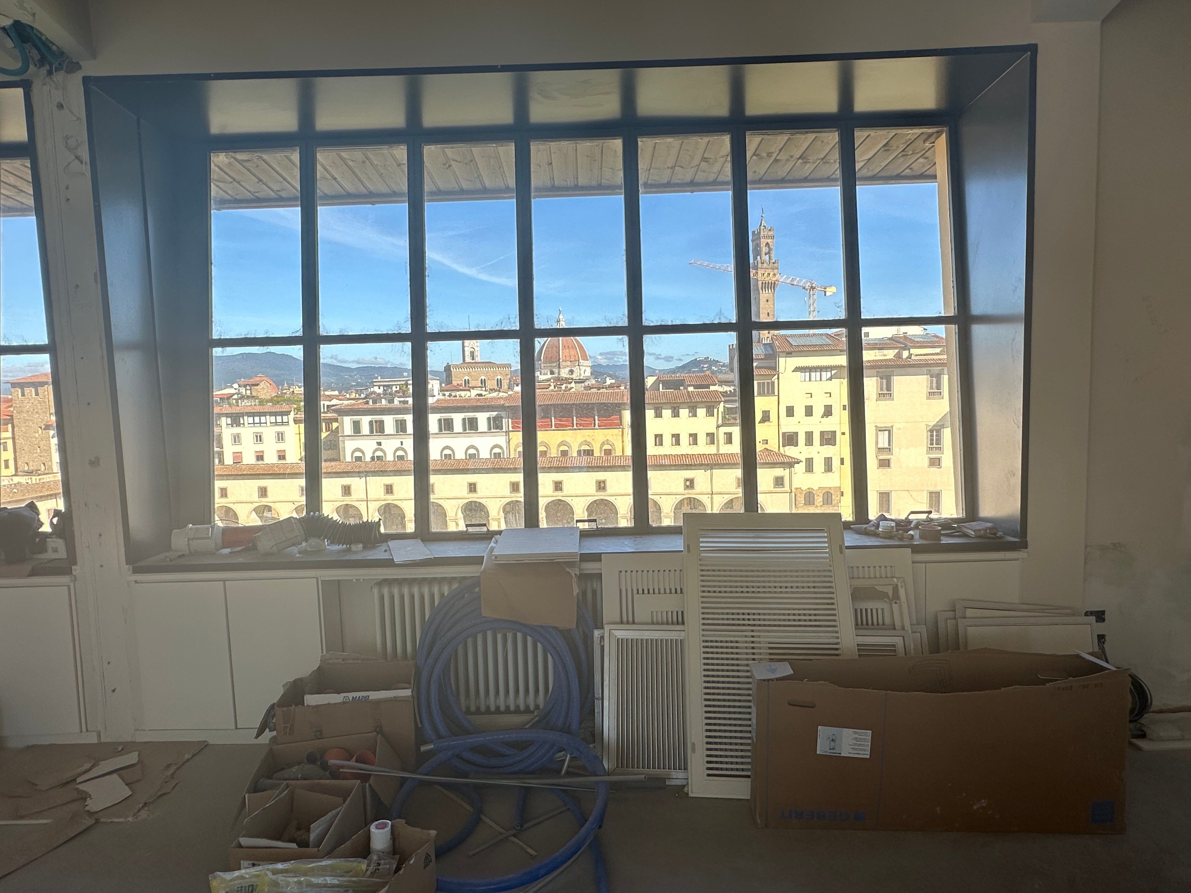 The window wall before the room was built around it, the city beyond