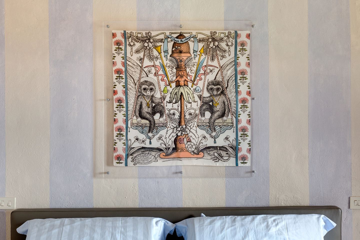 The framed print centred over the bolsters