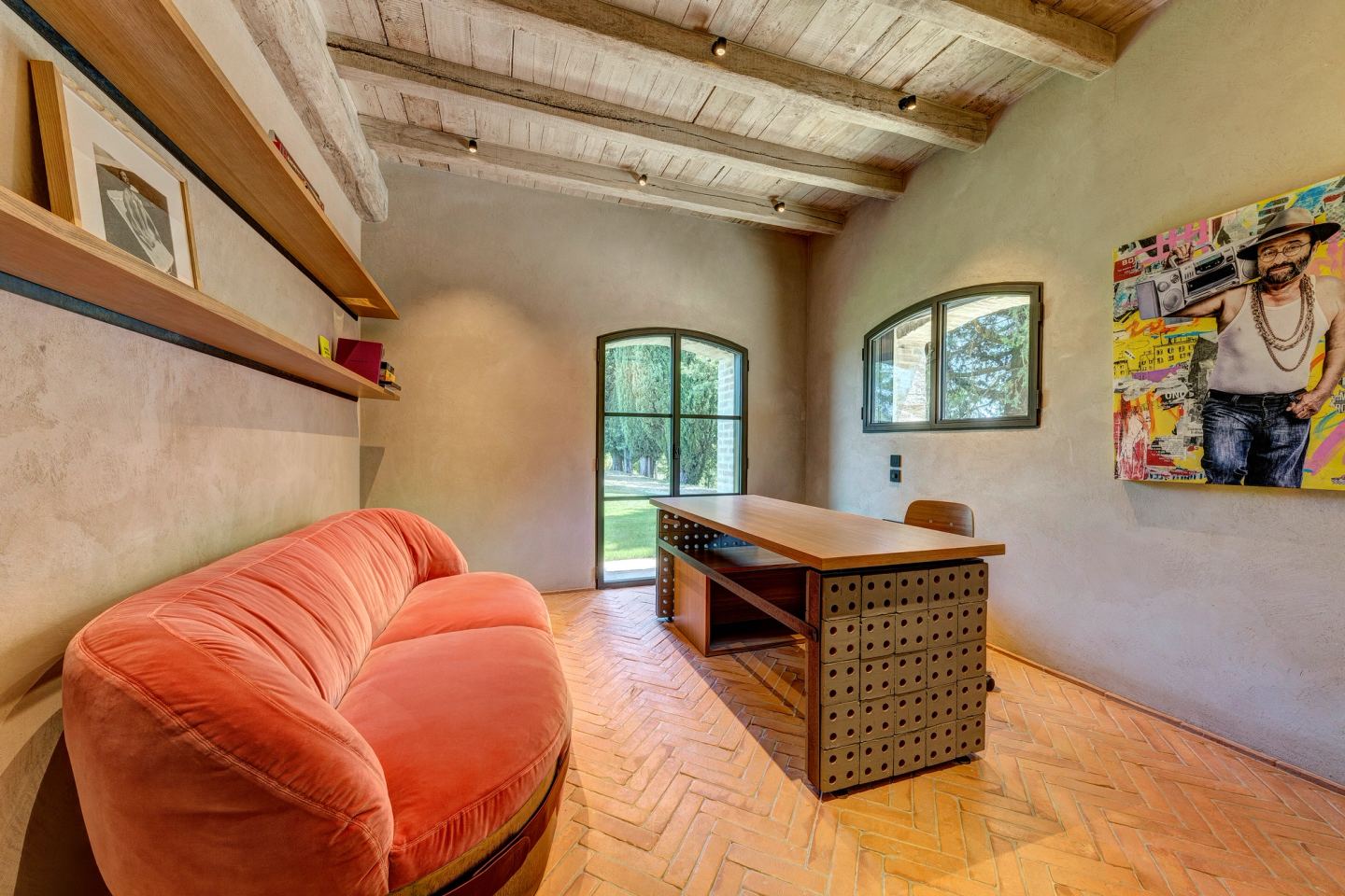 The sofa below the framed pictures