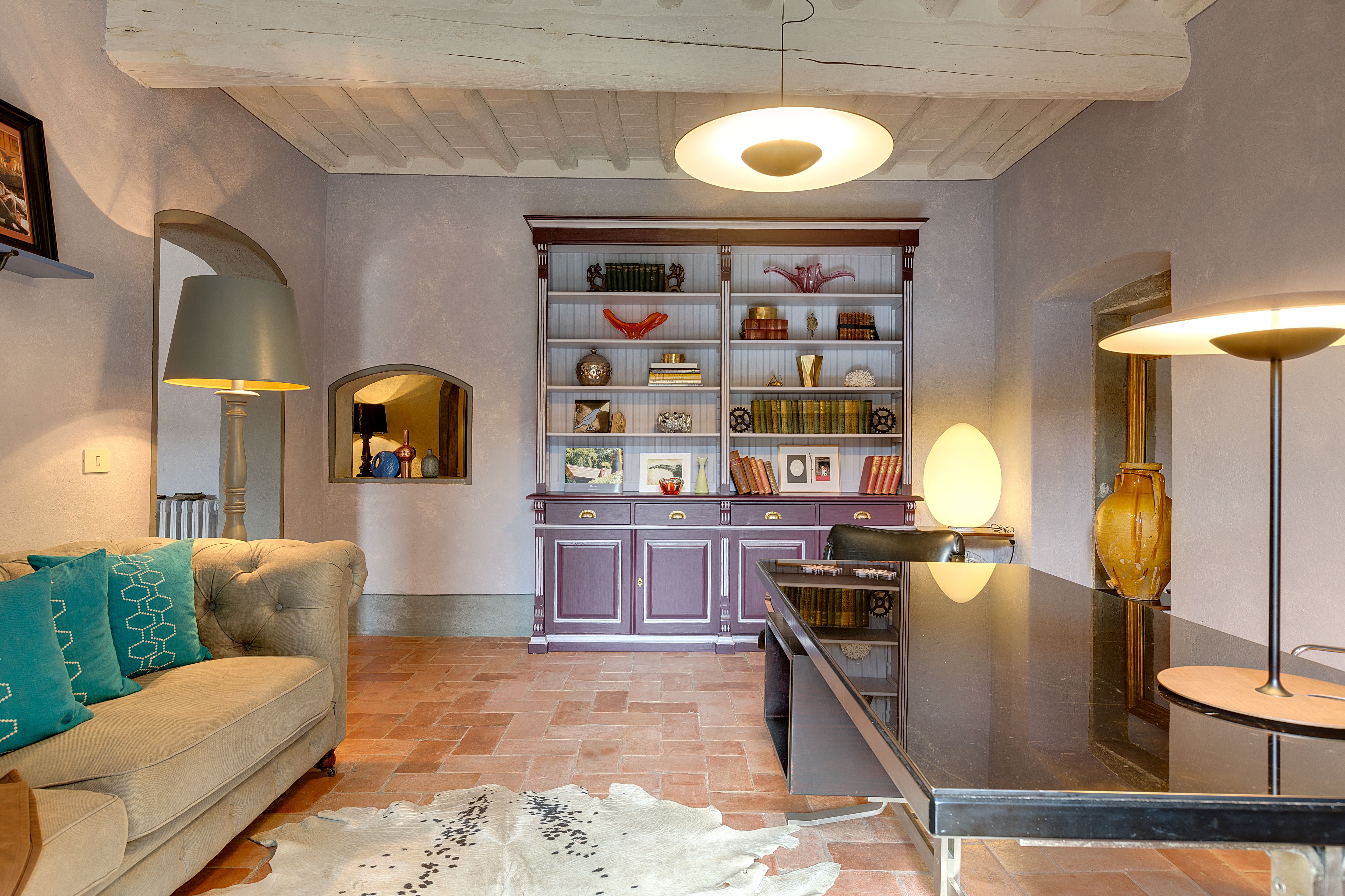 The library sofa below the fitted shelves