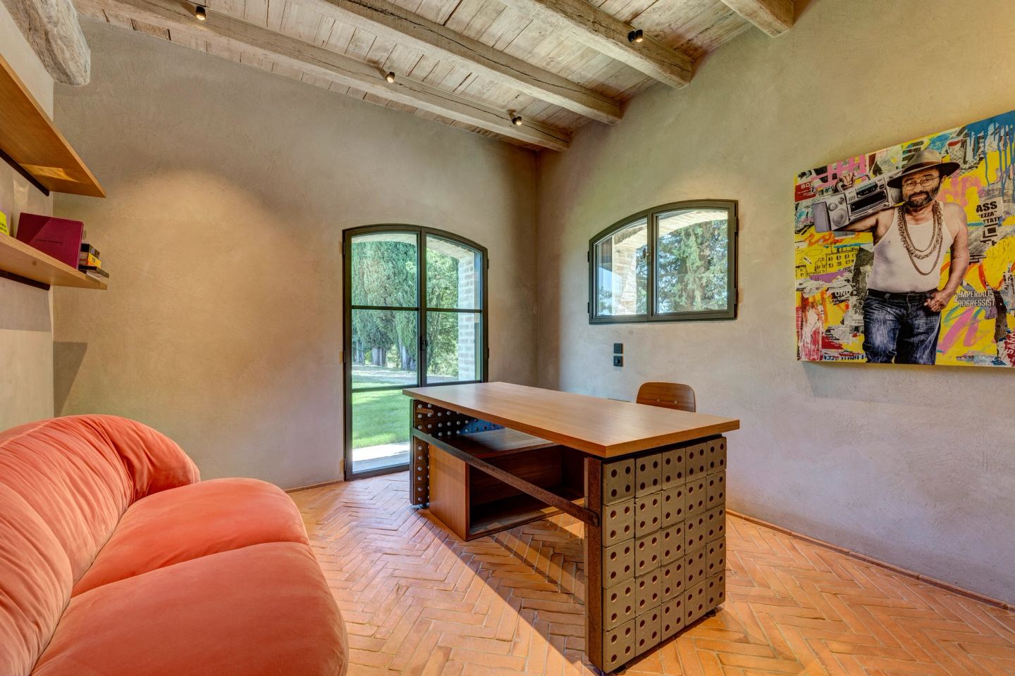 The sofa and the desk, the window between them