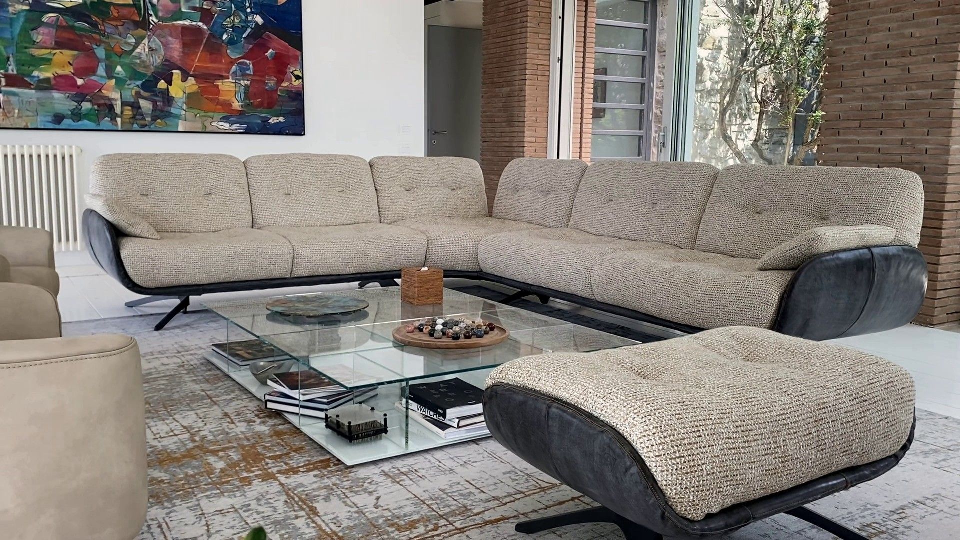 The Ayton corner sofa and its pouf in the first living room
