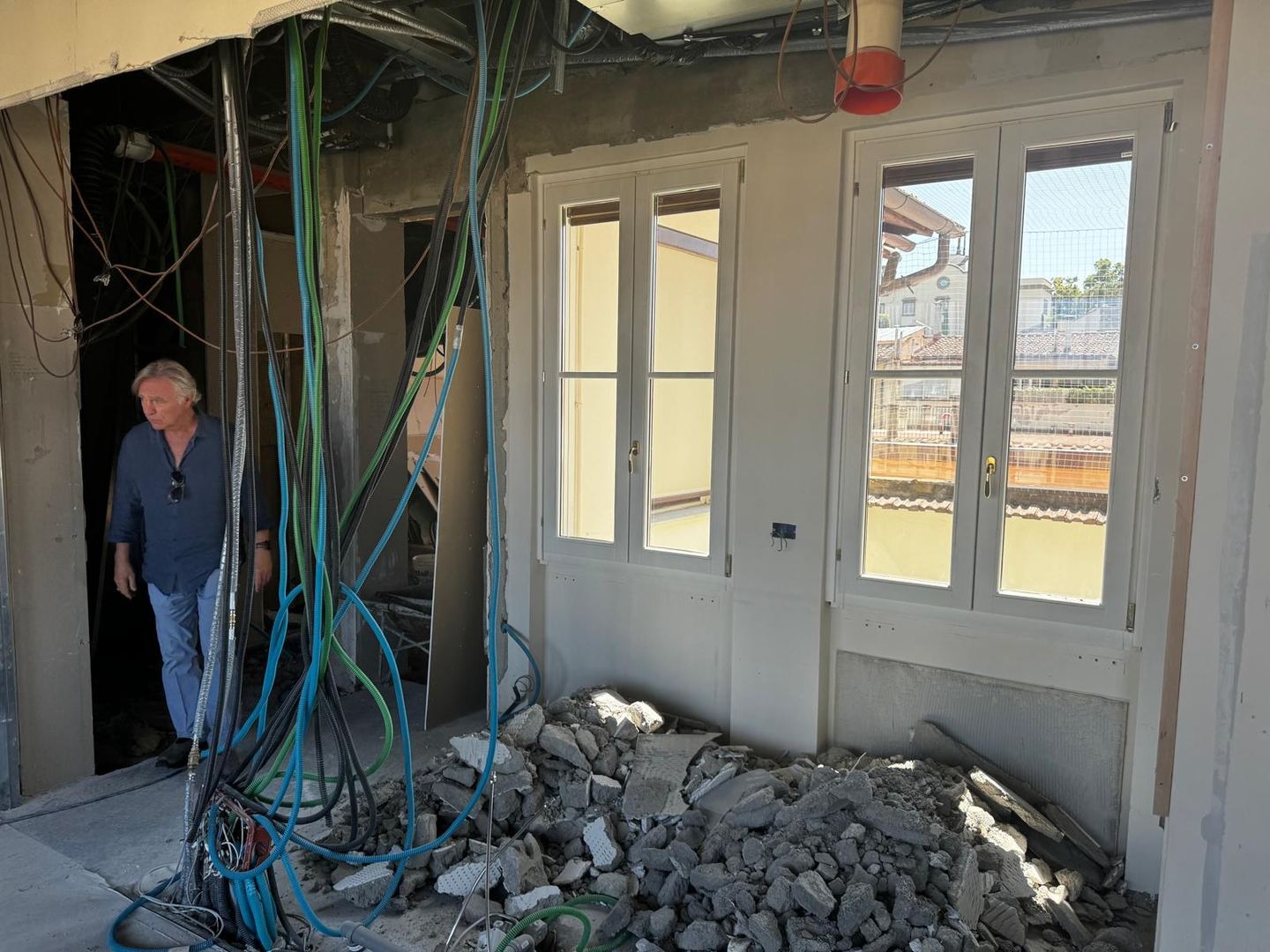 Rubble below a pair of French windows