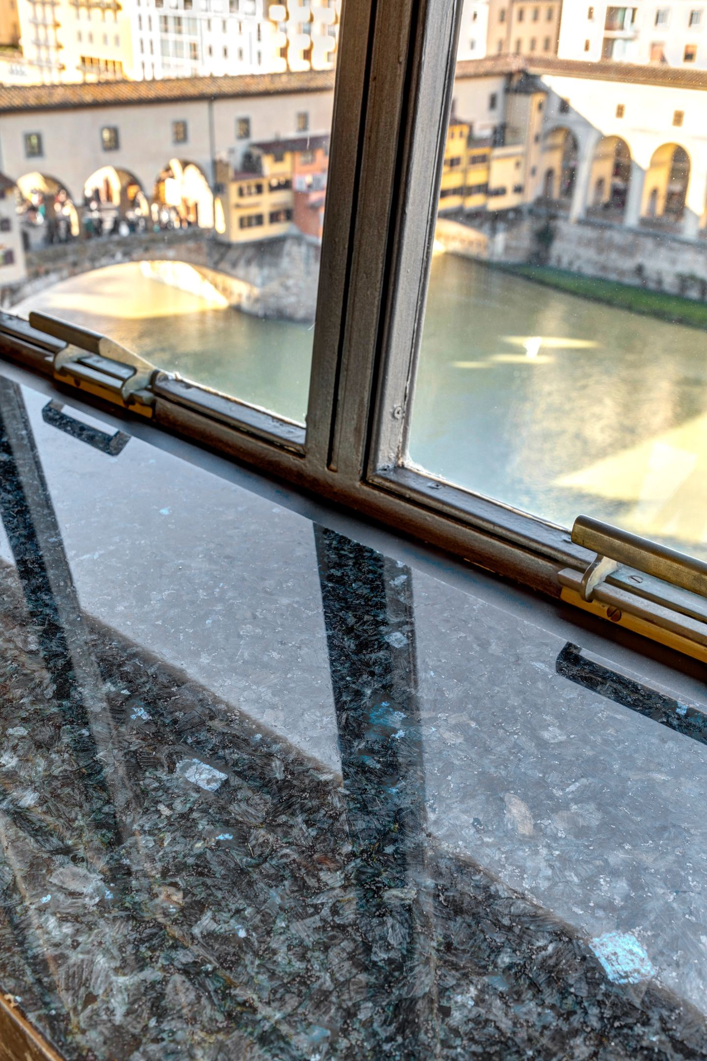 Stone sill and steel frame over the Arno at Ponte Vecchio