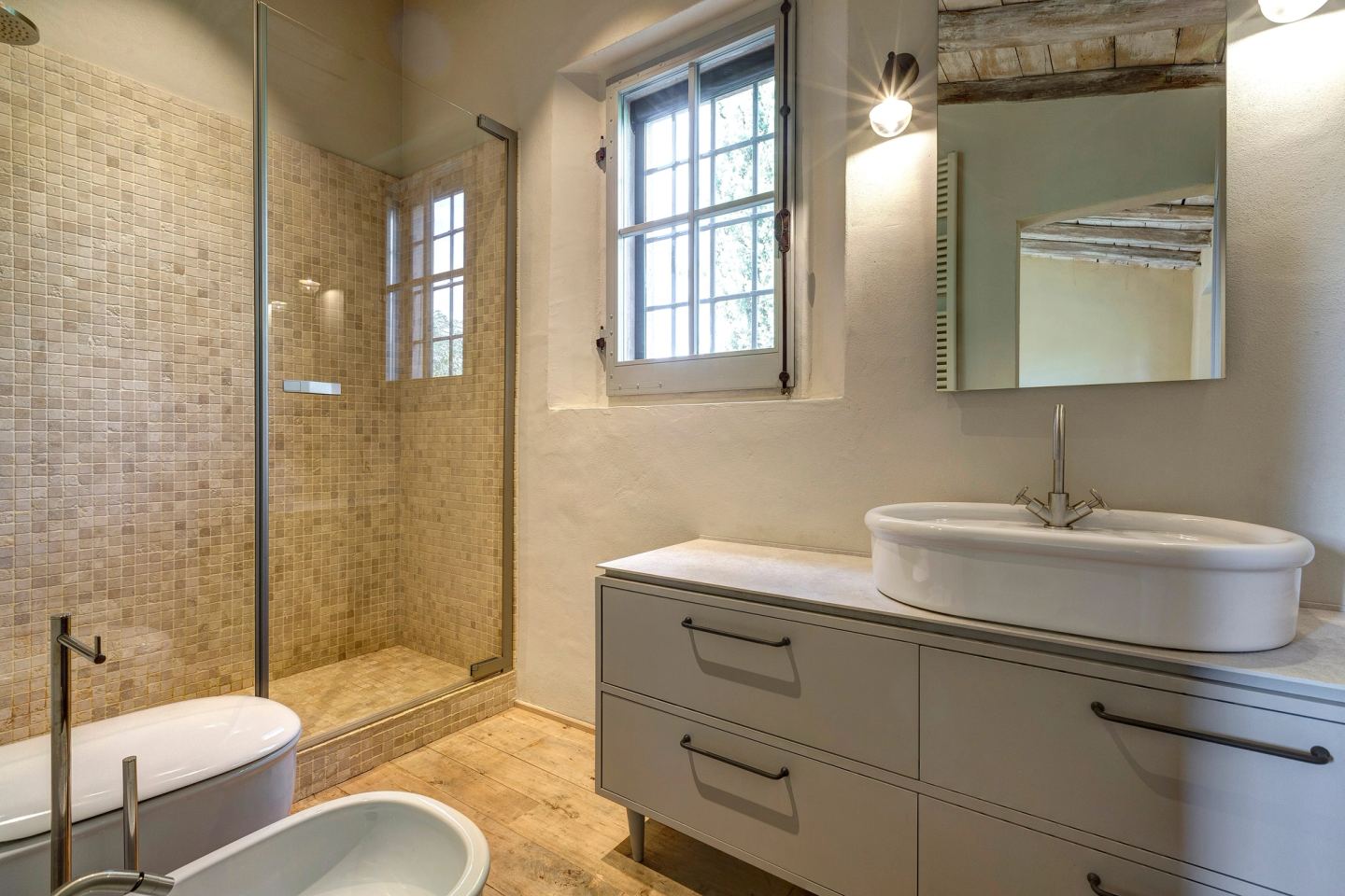 The second bathroom in the sleeping area: mosaic shower and a long cabinet