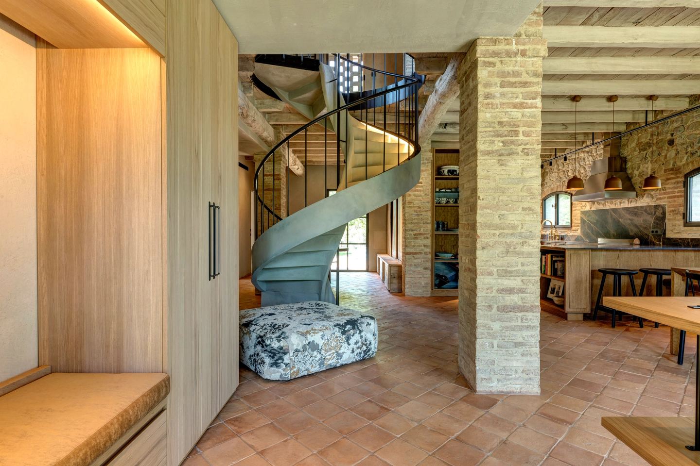 The stair from the entrance, a stone bench at its foot
