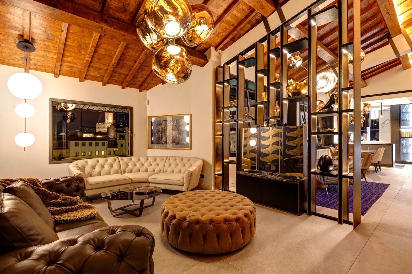 Sofas, ottoman and the library after dark