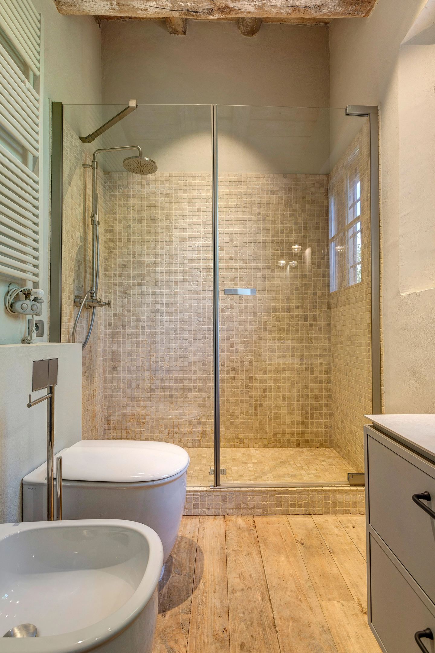 The walk-in shower in pale mosaic