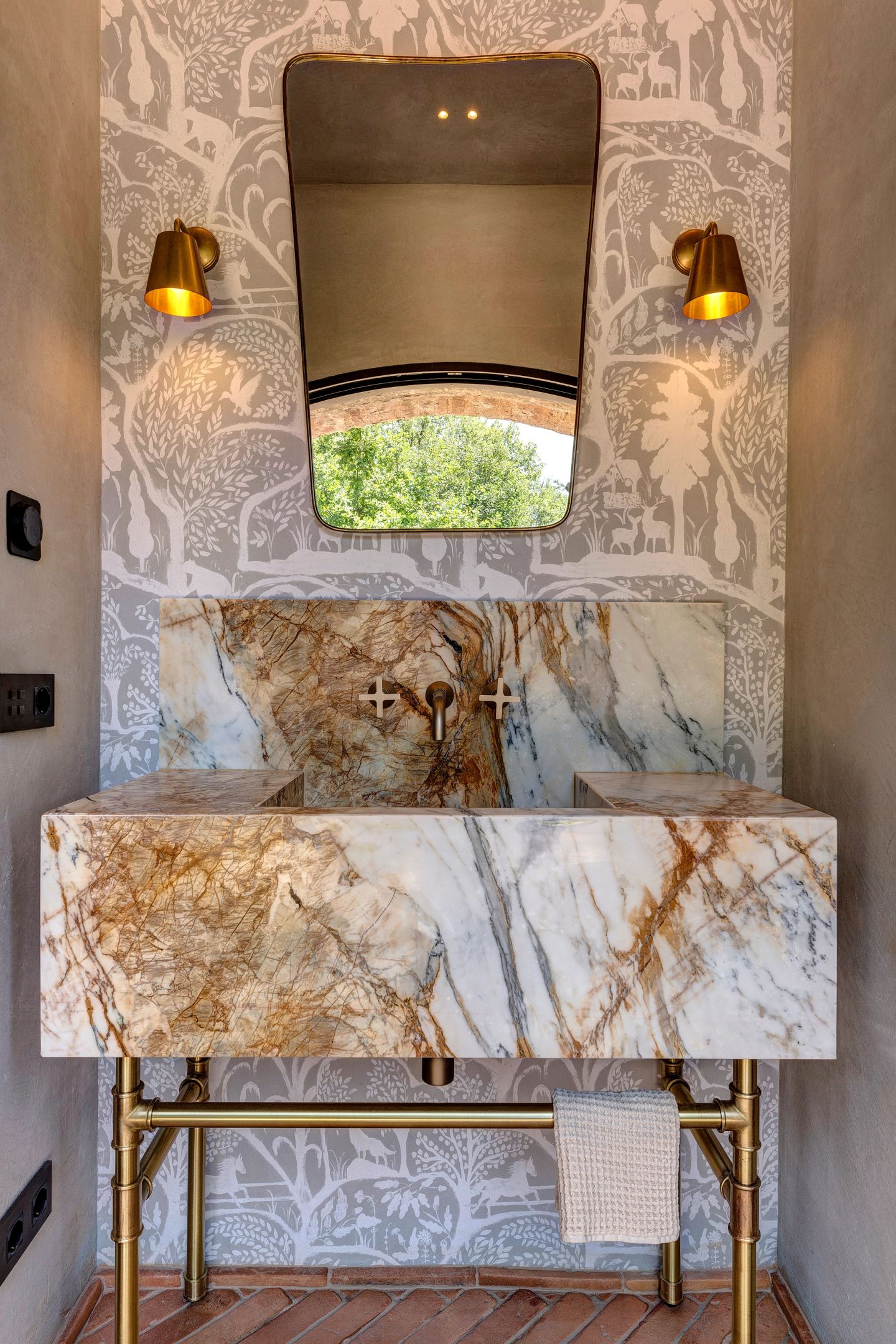 The console on its bronze legs, mirror above