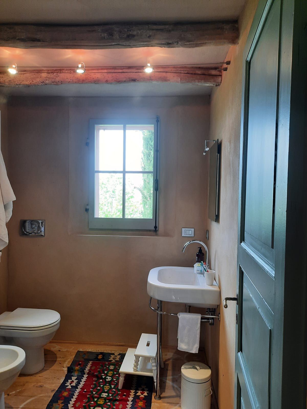 Before: a bathroom in the sleeping area, a freestanding basin