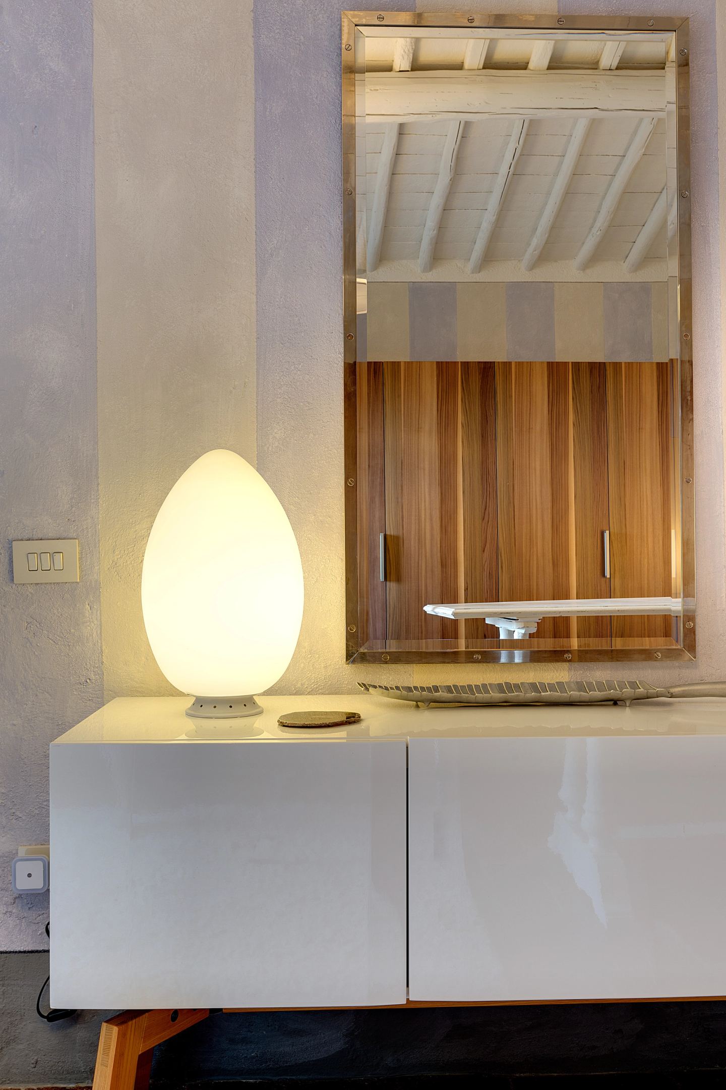 A glass shade and the walnut mirror