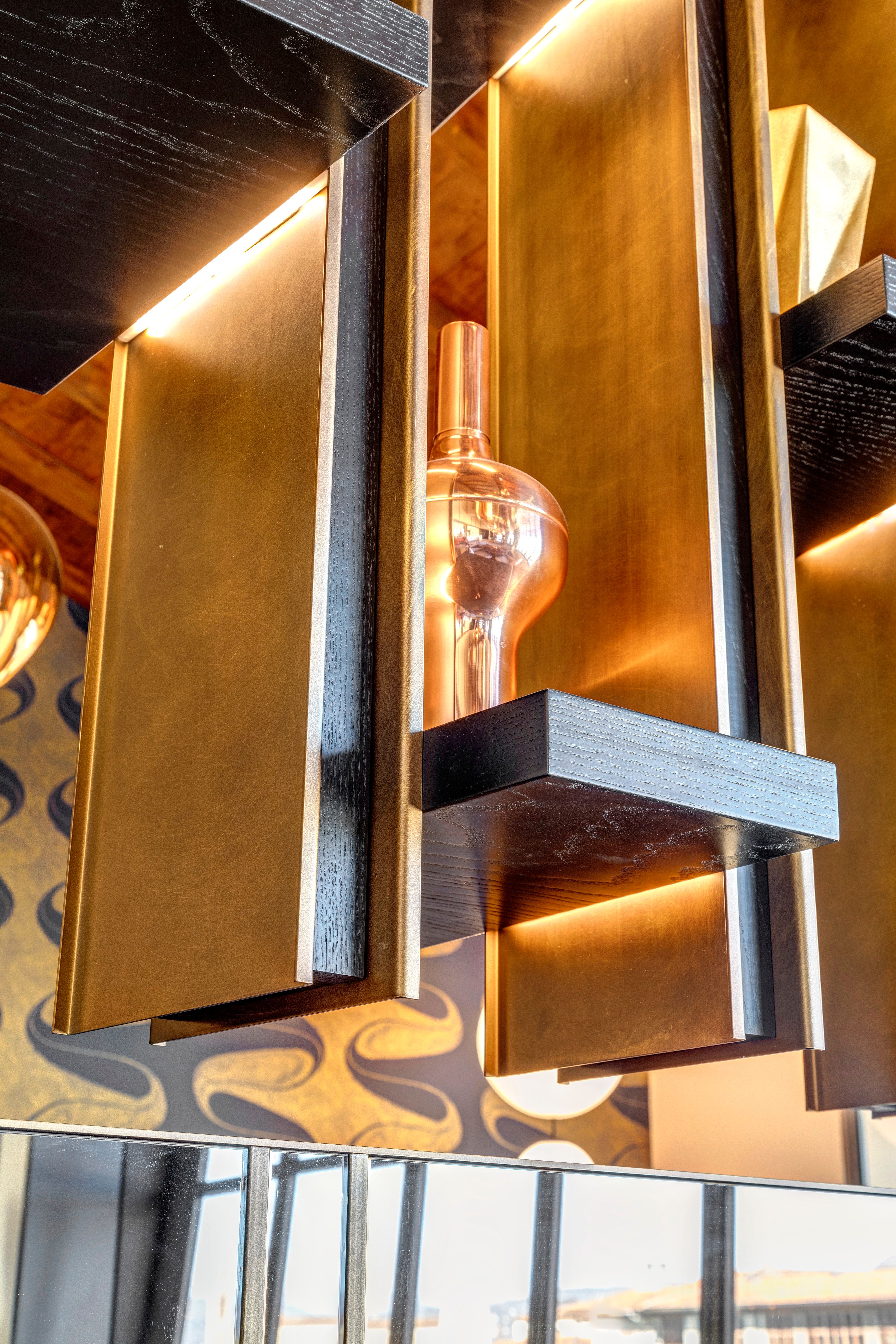 A brass light fitting against the library's frame