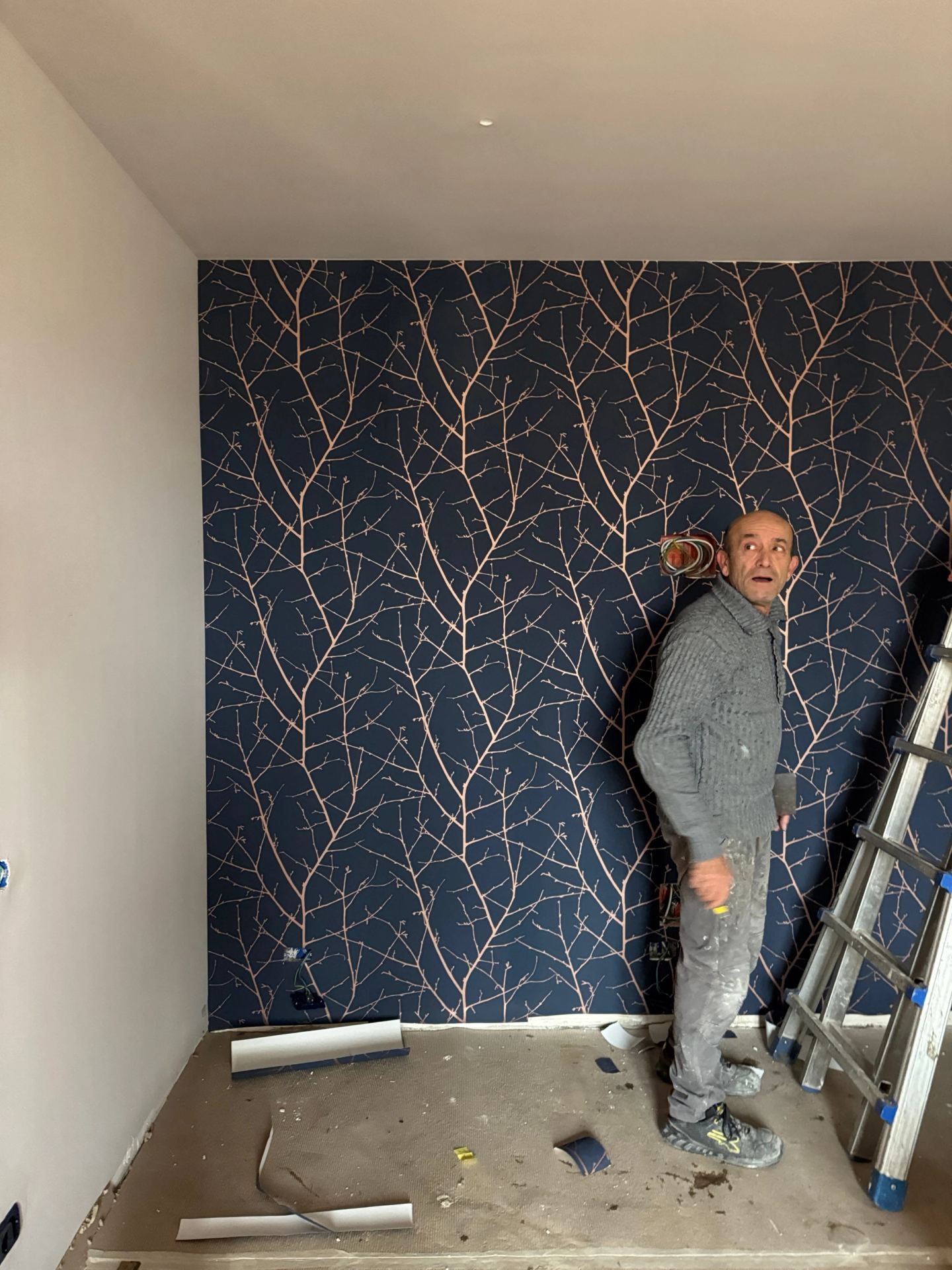 Hanging the branch-pattern wallpaper