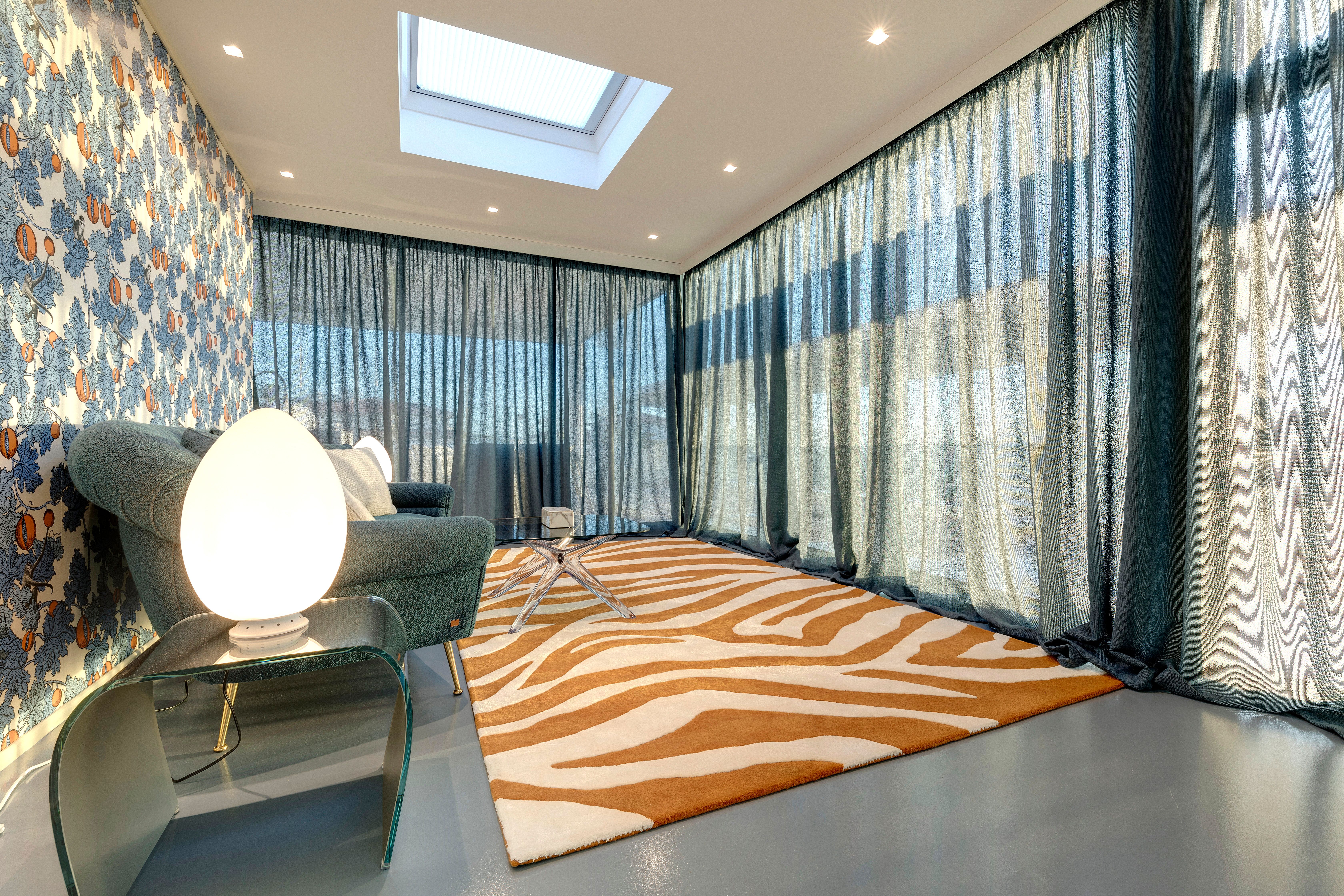 The veranda: Fornasetti paper, blue resin floor, skylight above