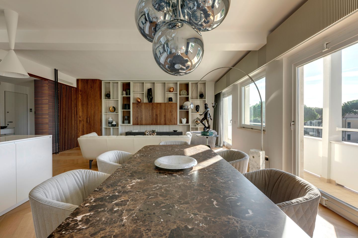 Marble dining table, close, the kitchen open beyond it