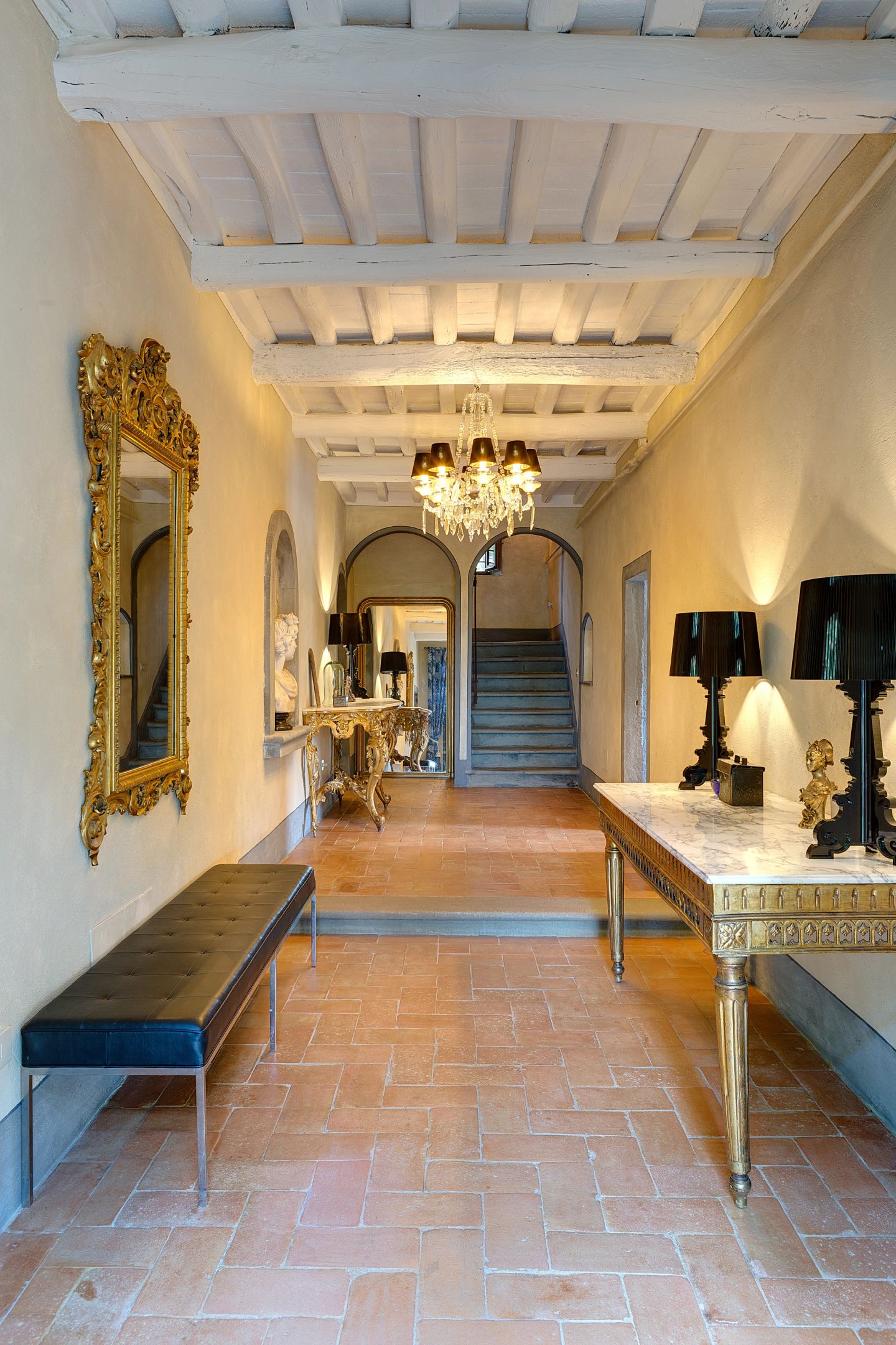 The hall towards the stair, gilt against terracotta