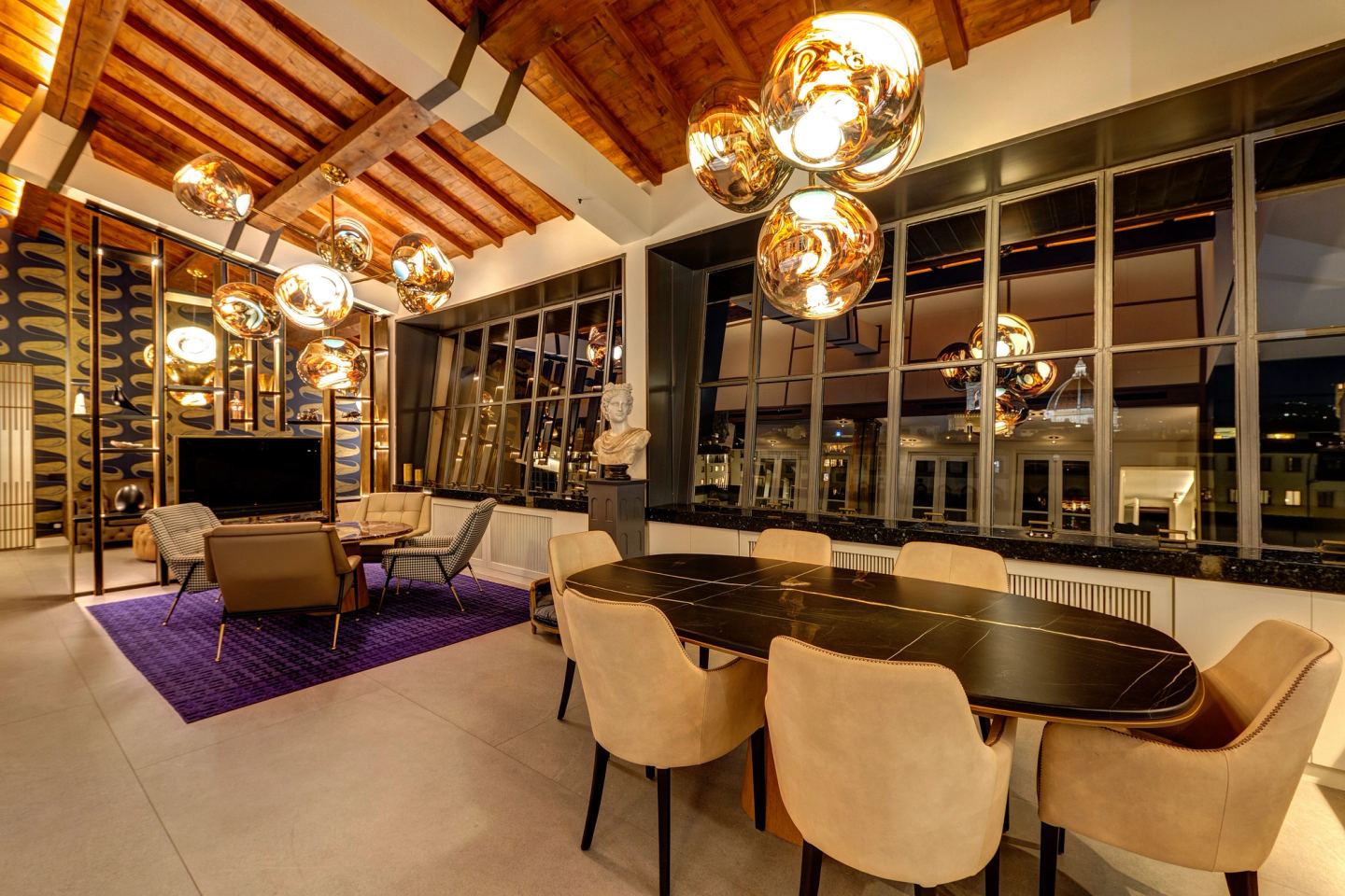 The dining table at night, the copper globes over it