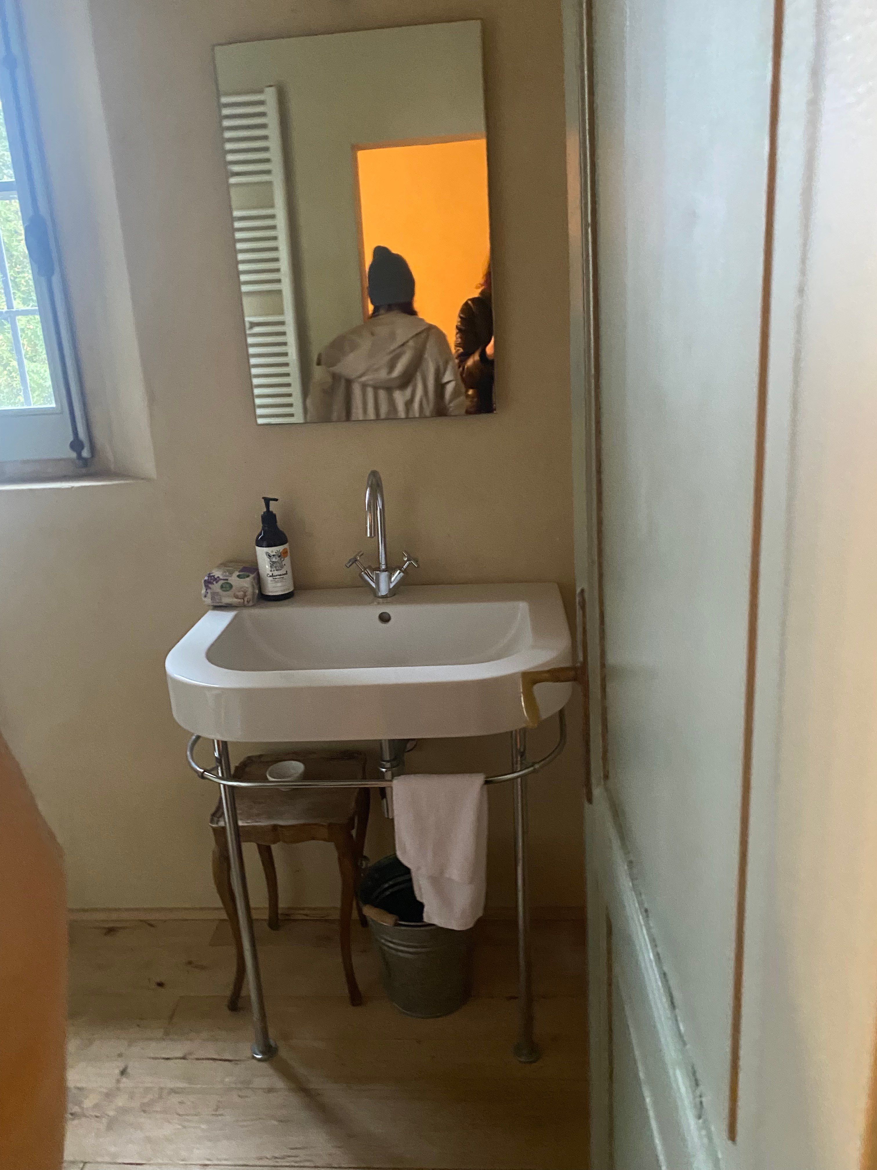 Before: the second bathroom's basin under the window