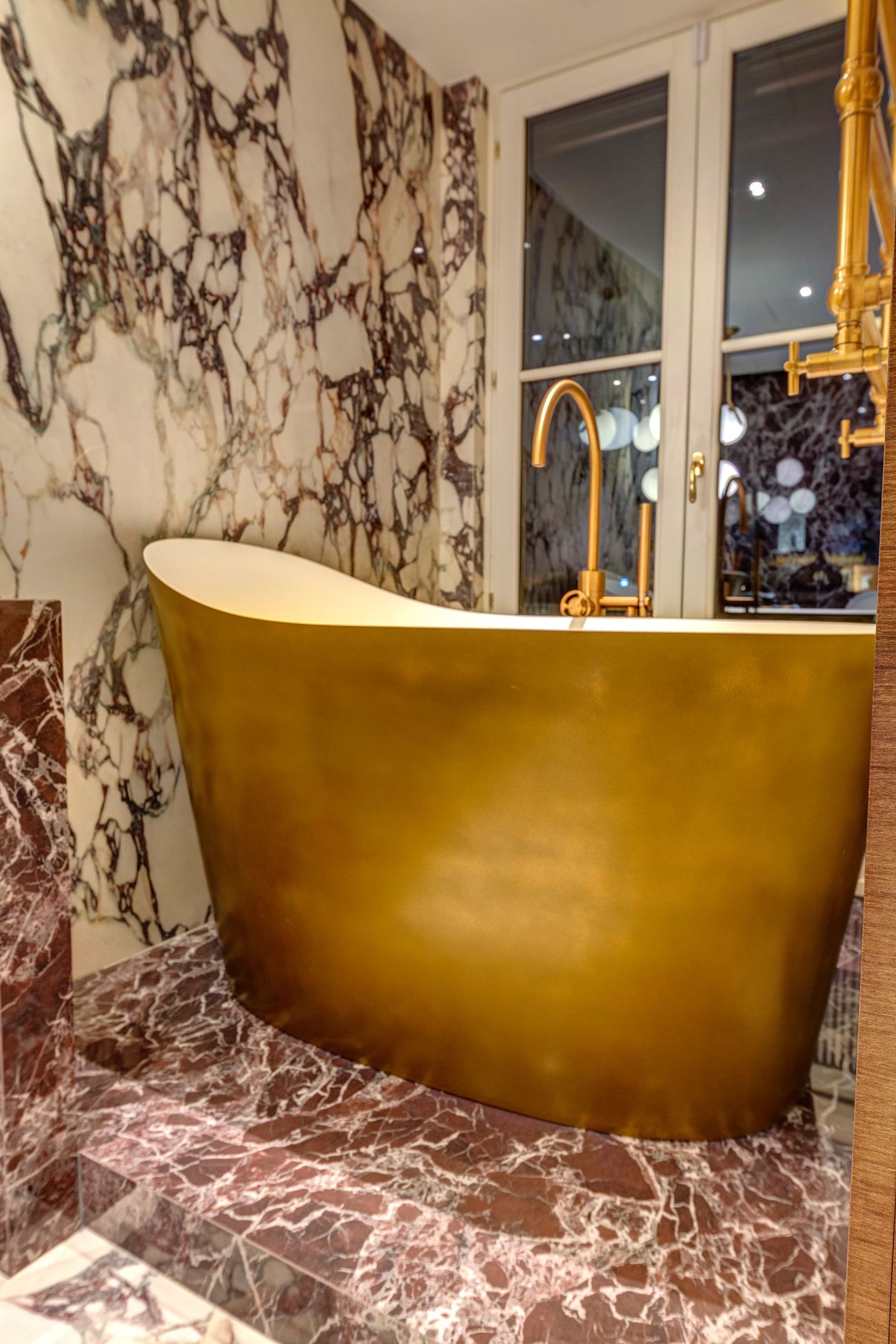 The bath and the lit window together after dark