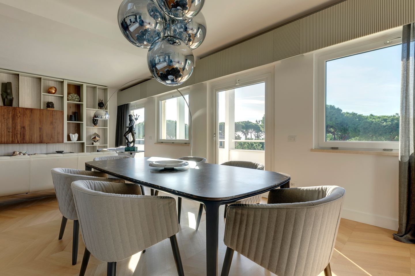 Dining table seen from the living room, TV wall behind