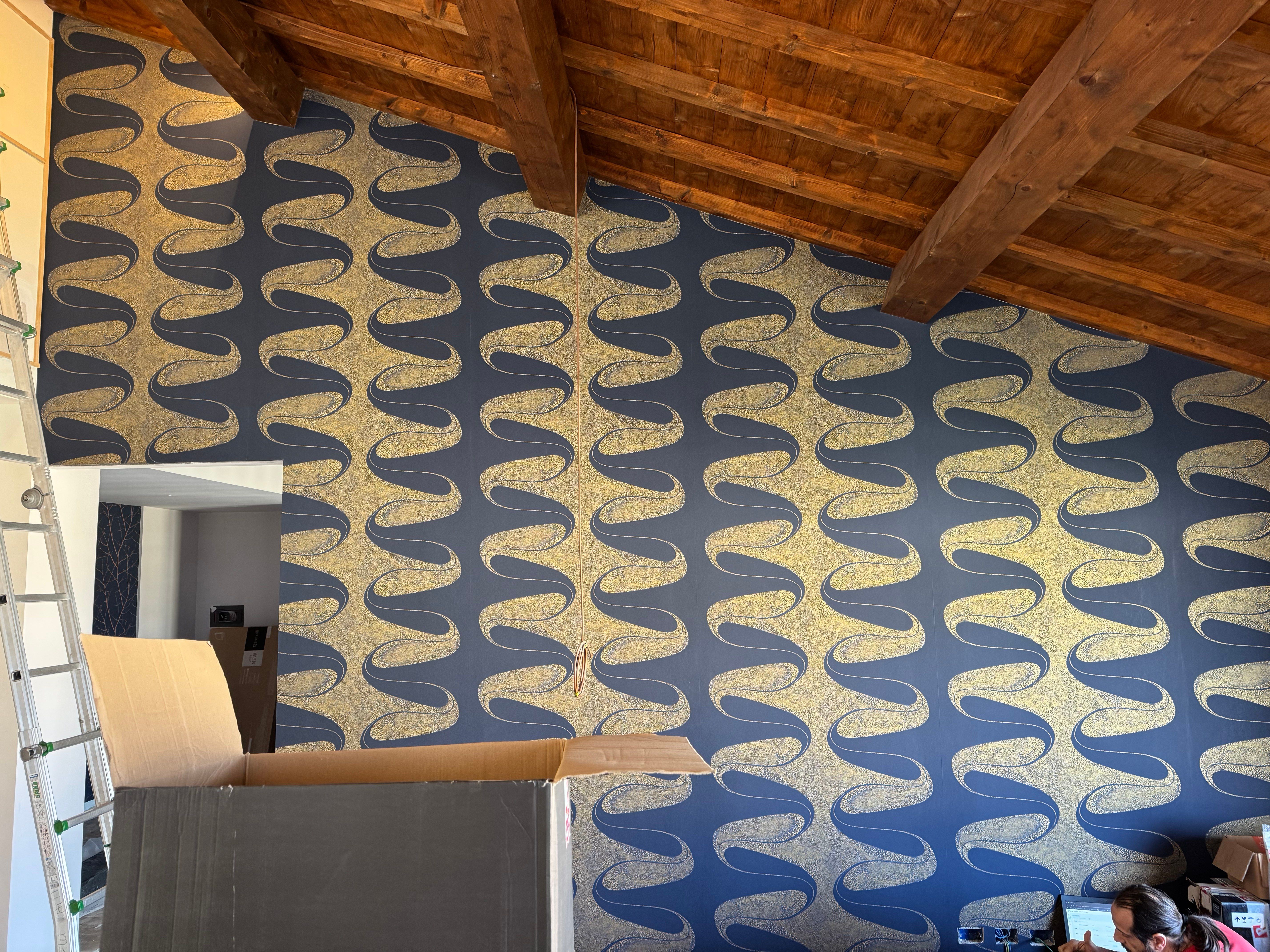 The patterned wallpaper going up under the roof beams