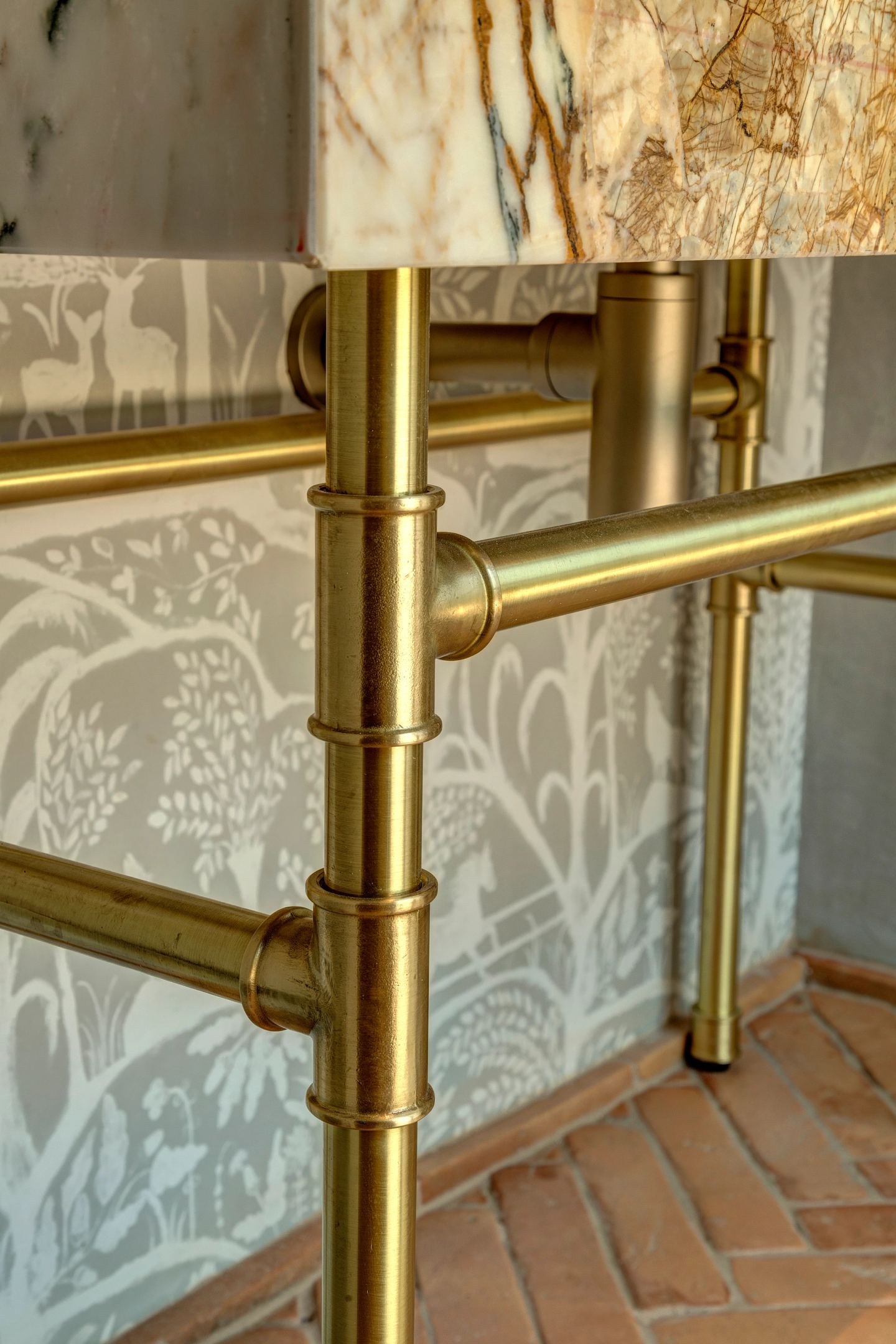 The brass rail against the printed paper