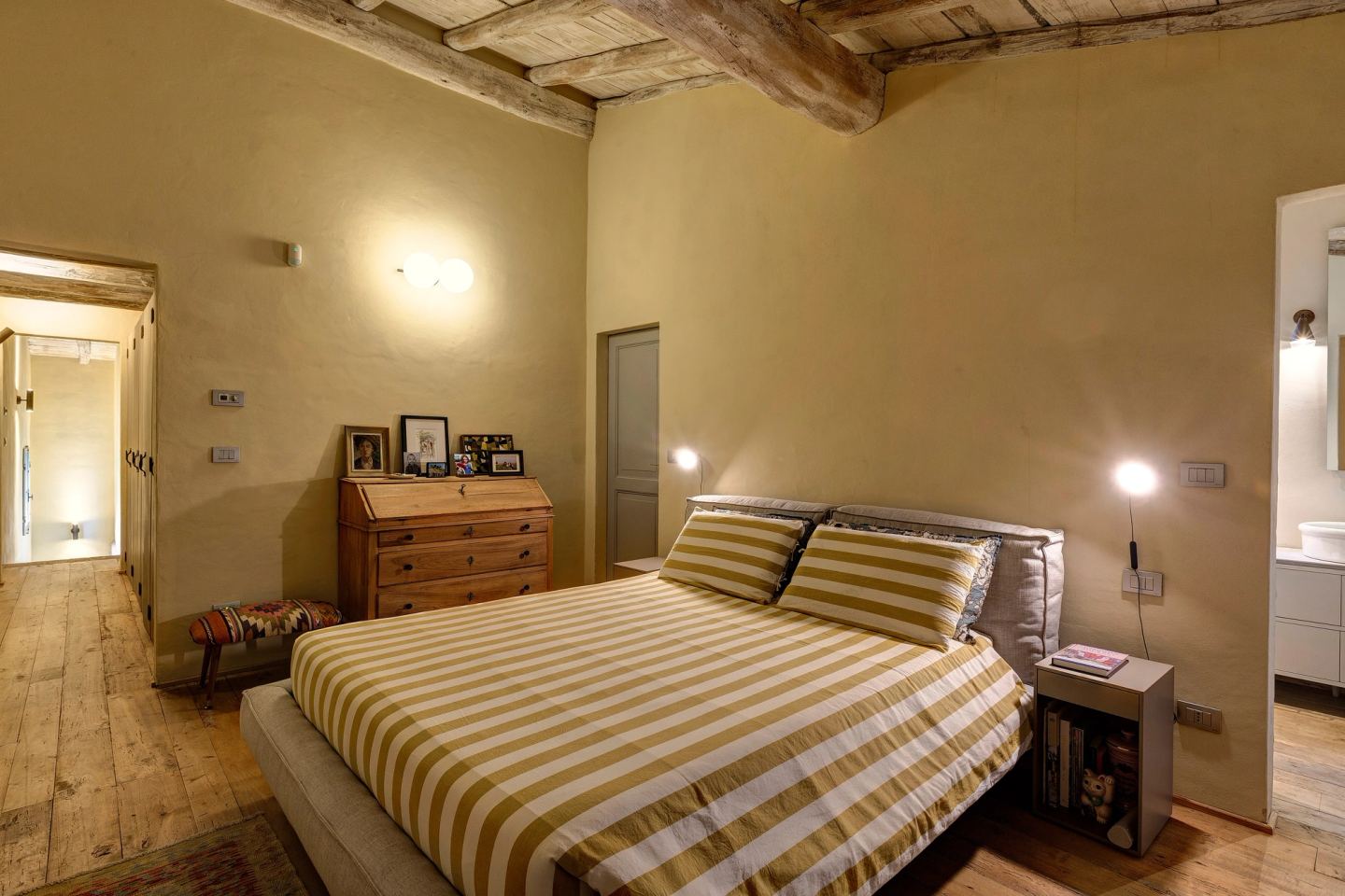 The bed and its reading lights, the corridor running off to the left