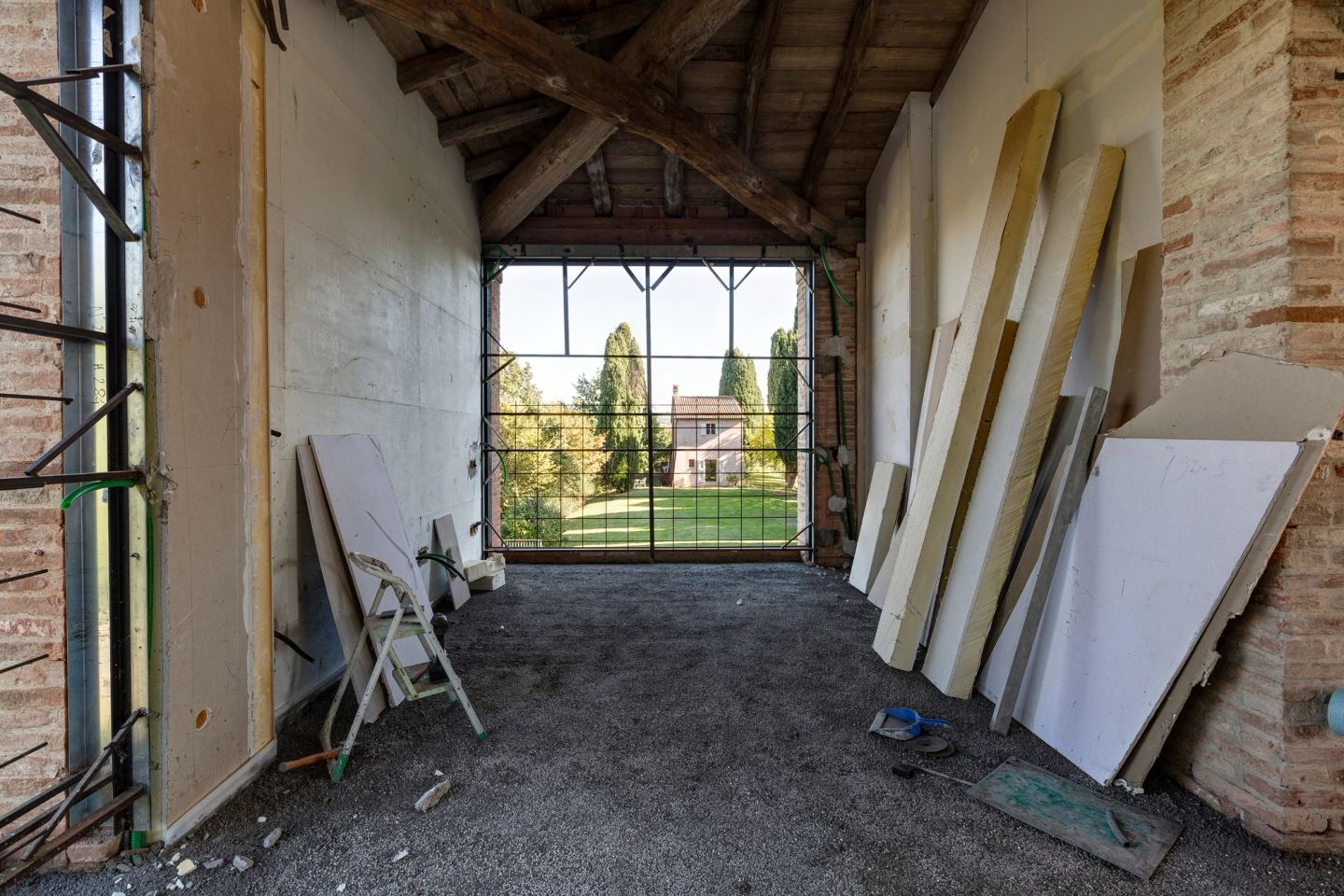 A long upper room, the garden framed at the far end
