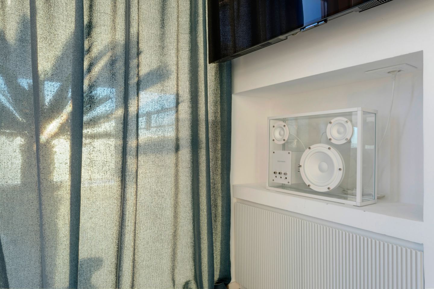 Sheer curtain against the window, screen above the radiator