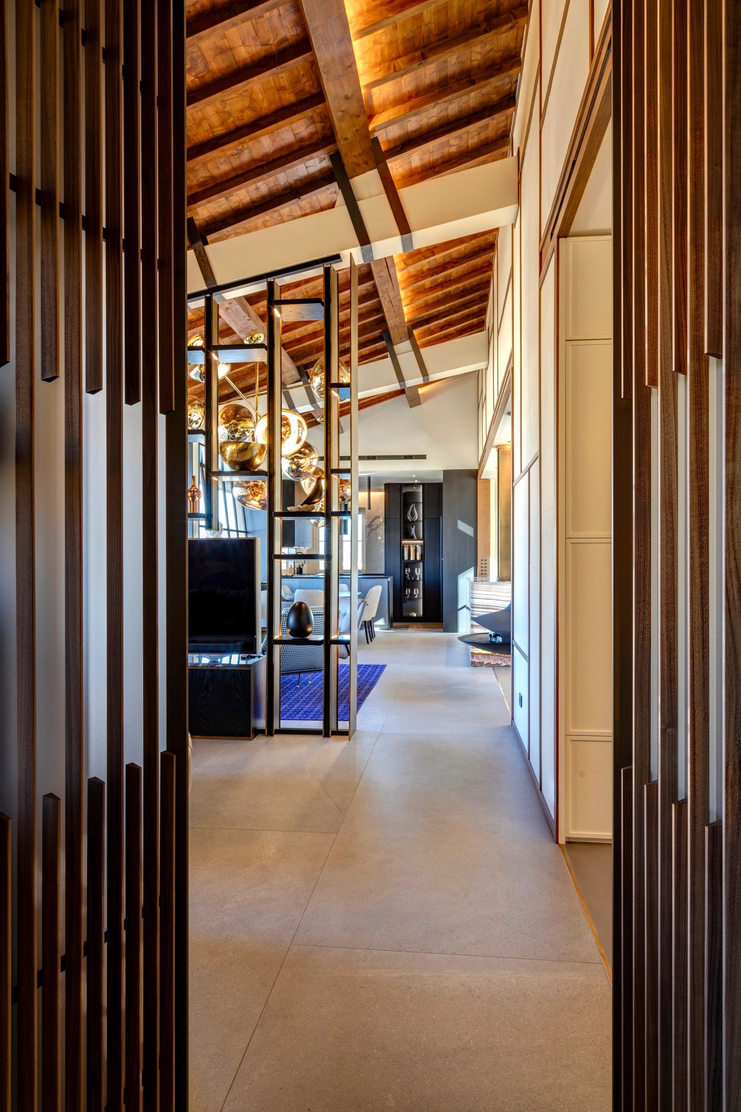 The corridor running behind the slatted screen