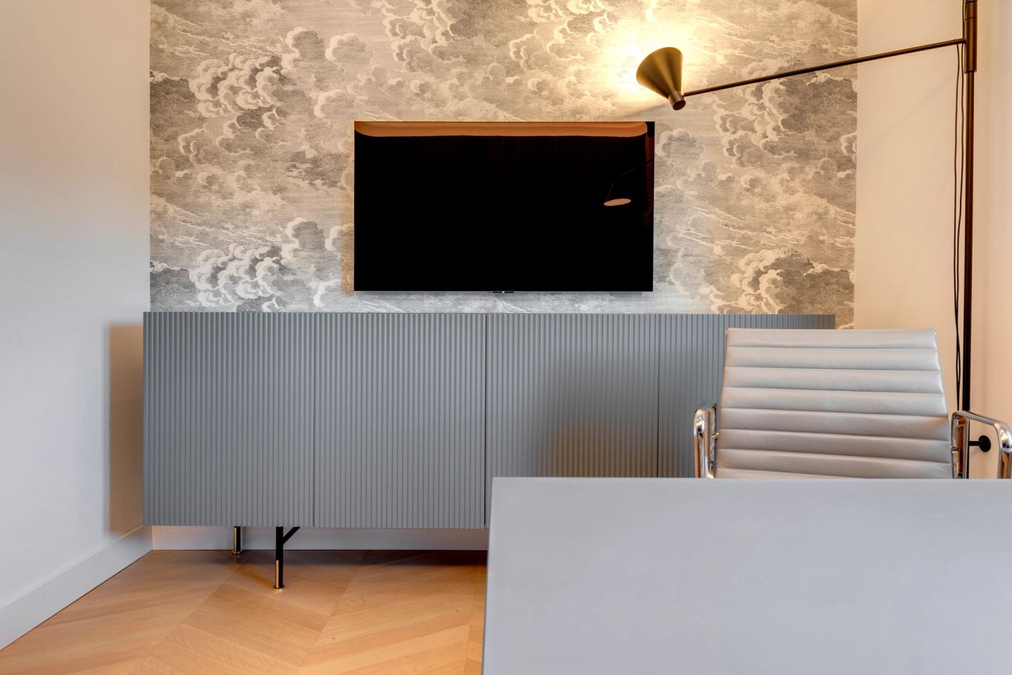 Wall-mounted screen and the articulated brass lamp