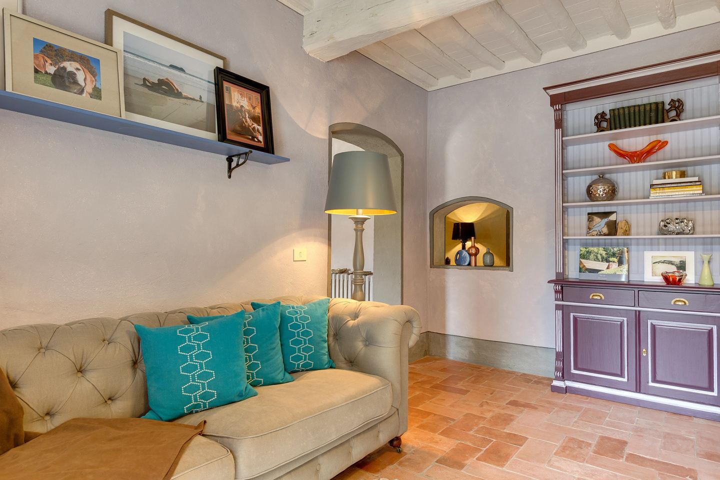 Turquoise cushions against the lilac joinery