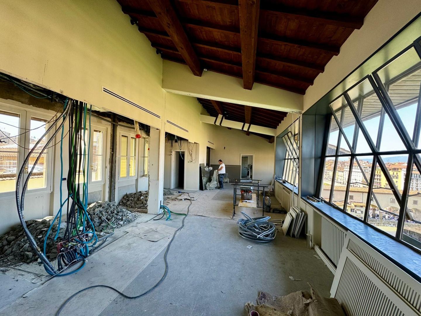 The length of the apartment, walls opened and services hanging