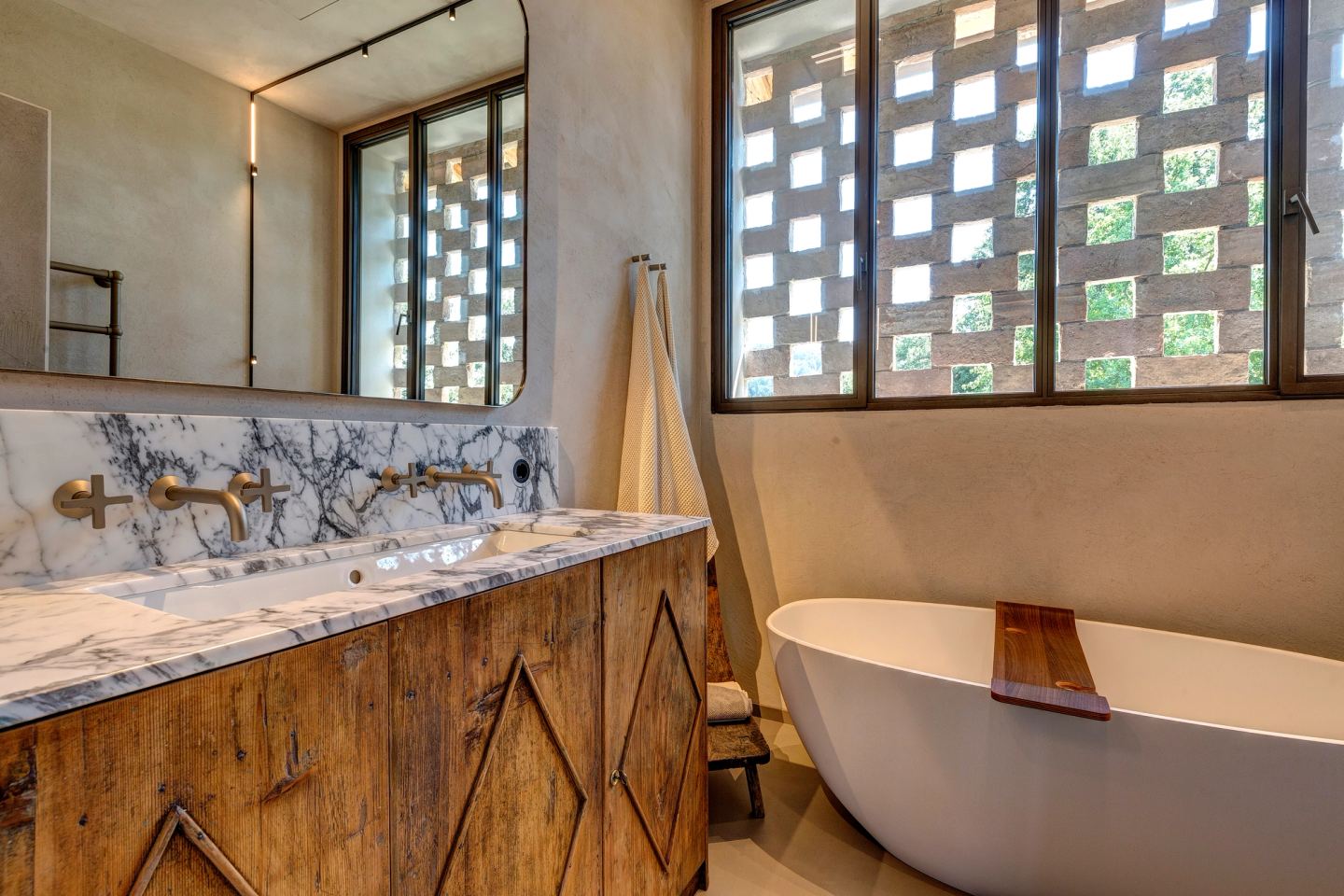 The vanity and the bath under the glass-block window
