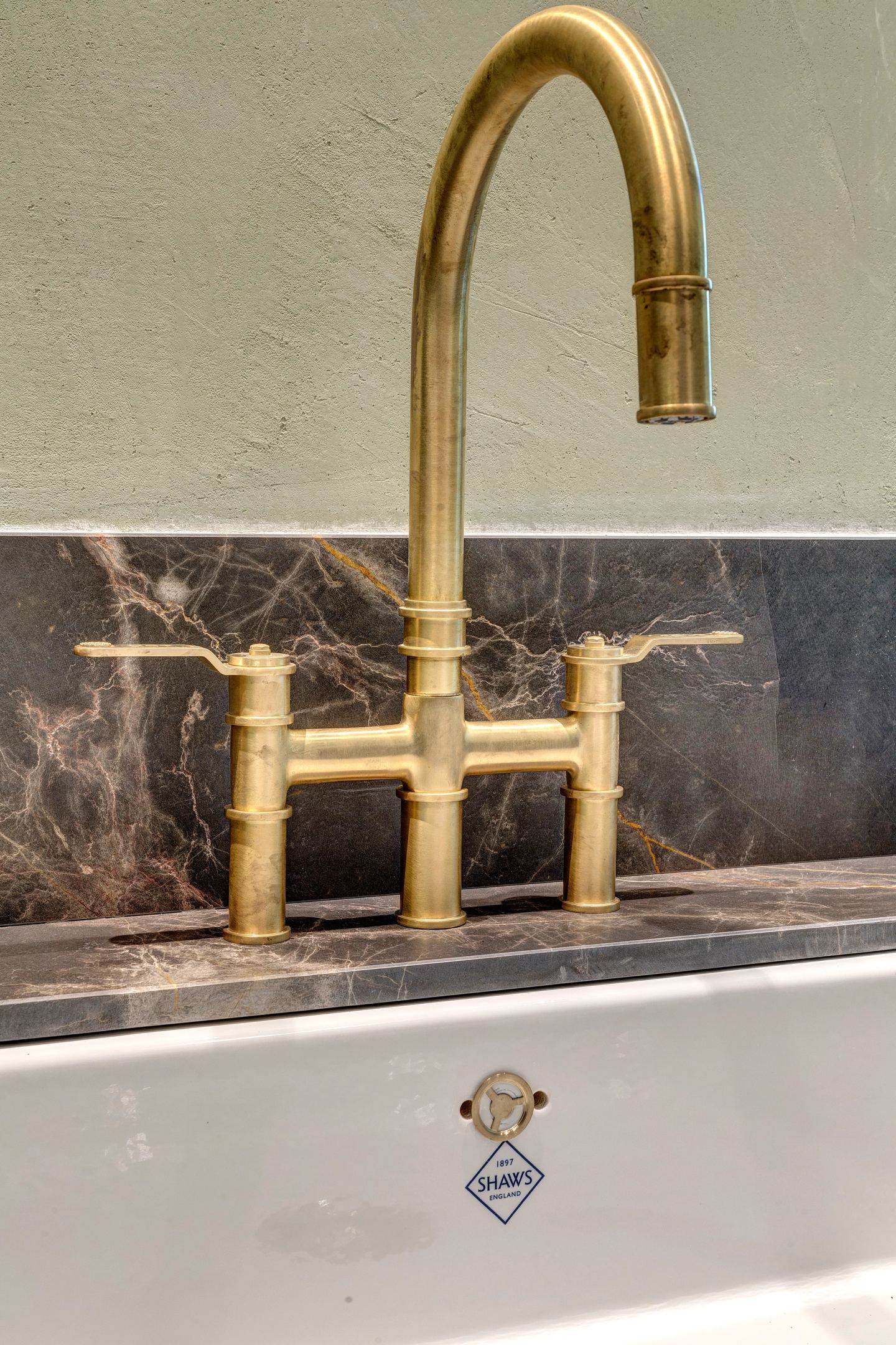 Brass bridge tap over the fireclay sink
