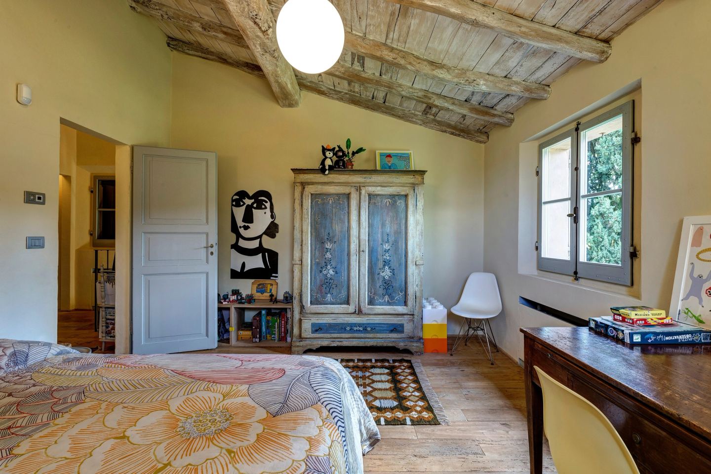 The room towards the door, the painted wardrobe and the desk