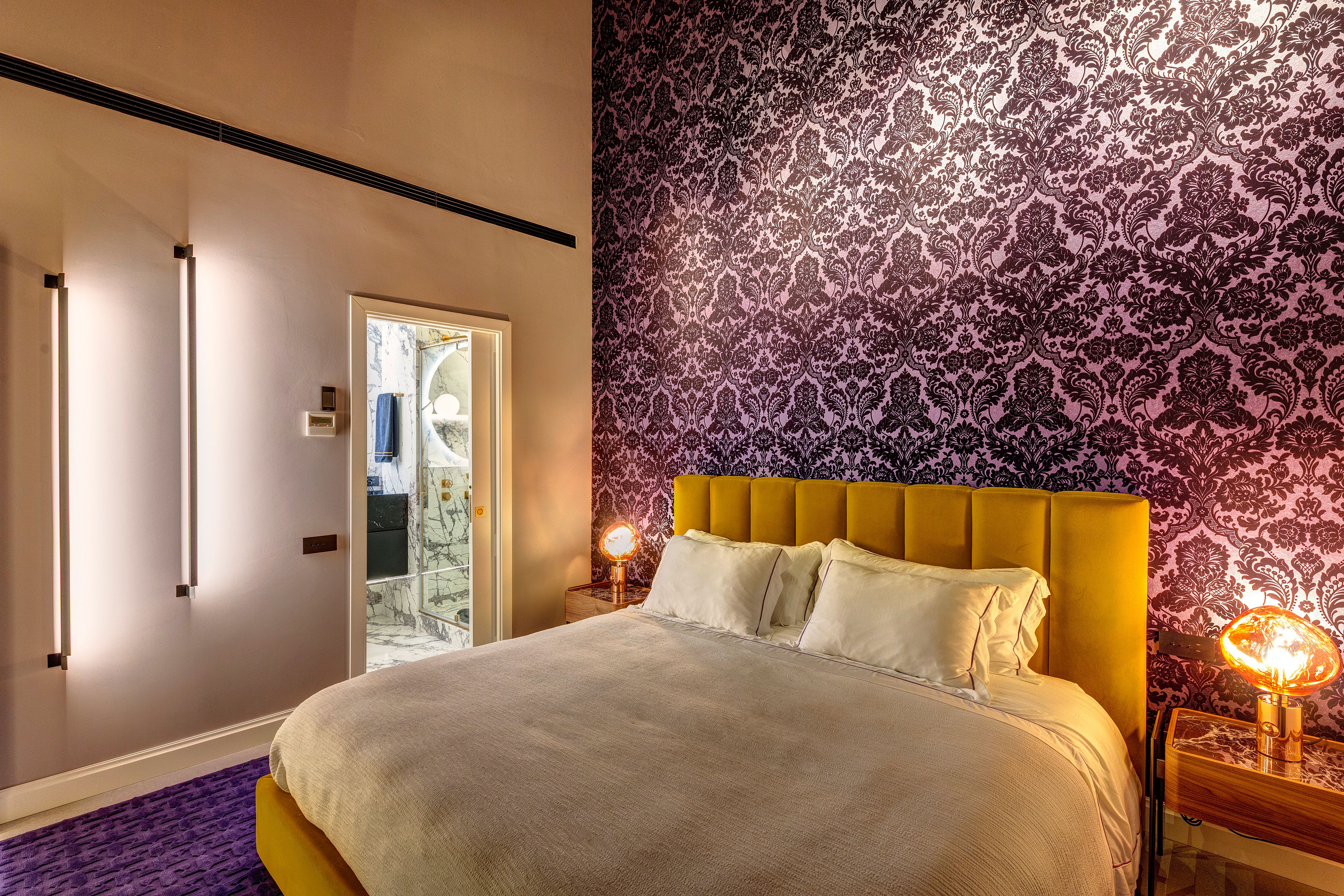 The bedroom at night, the door to the bathroom open