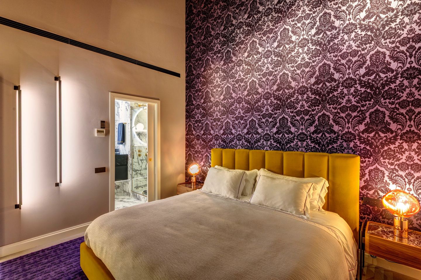 The bedroom at night, the door to the bathroom open