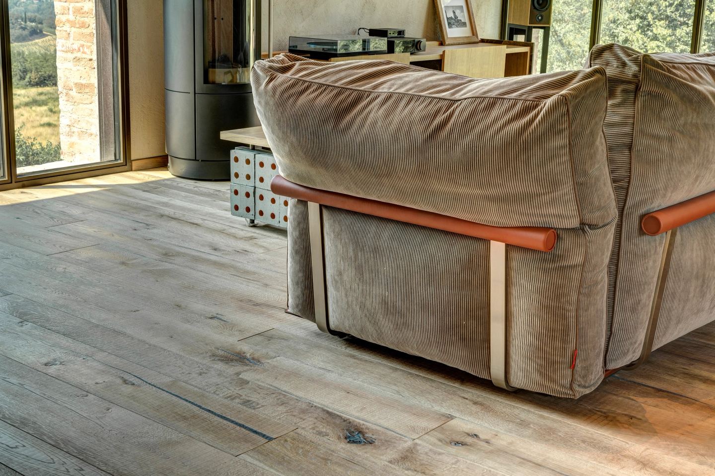 The velvet sofa on the oak boards