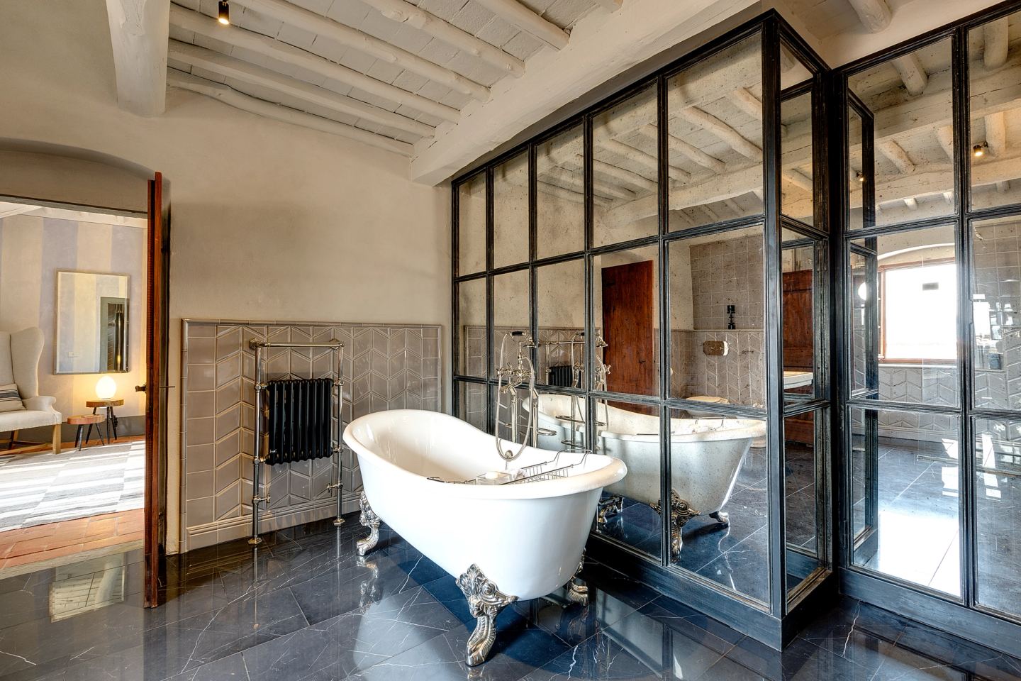 The glazed wall standing between bathroom and bedroom
